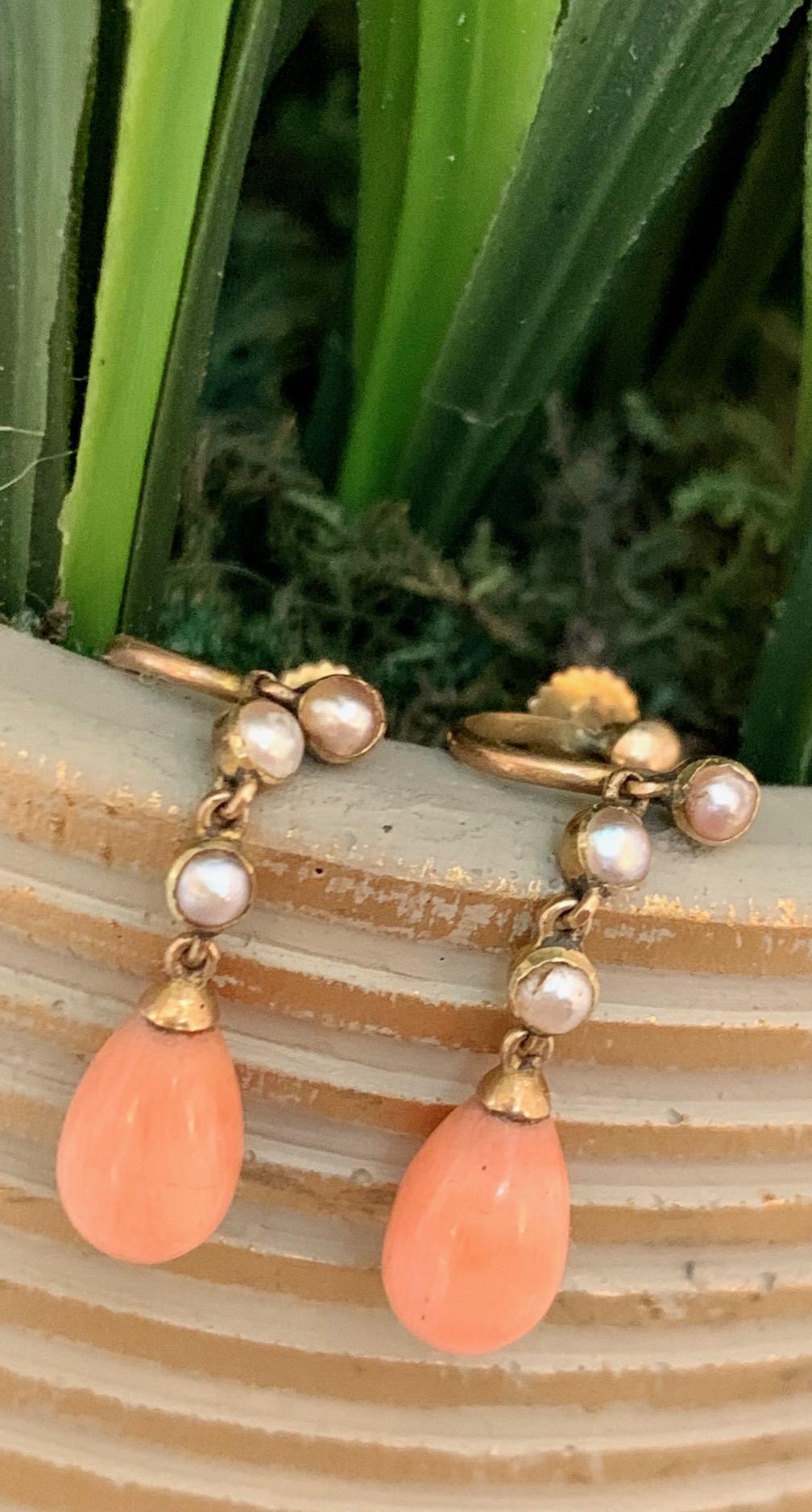 These simply lovely earrings each feature a 10mm teardrop-shaped salmon Coral stone.  Accents are provided by 3-2.5mm half Pearls on each earring.

Weight: 2.3 grams