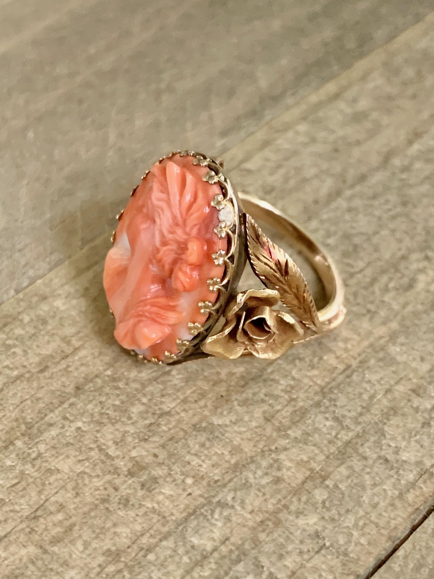 This fabulous vintage 14 karat yellow gold Salmon Coral Cameo ring has beautiful gold flowers carved on either side of the cameo.

This ring features:
1 oval coral cameo featuring a woman's profile.

Weight:  8.5 grams
Size: 5 3/4

This piece is so