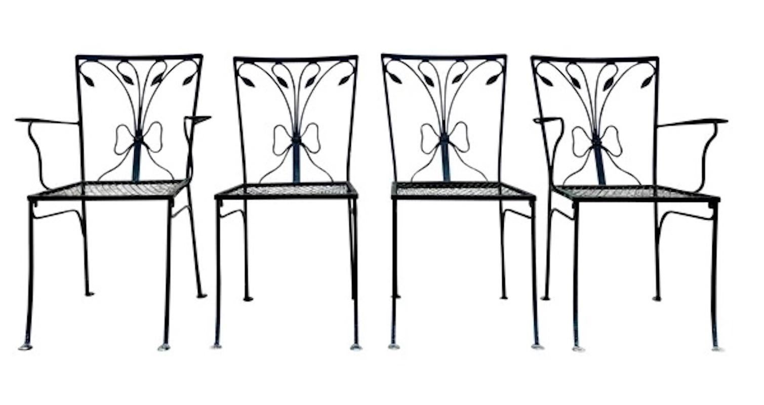 Vintage John Salterini 4 piece leaf and bow scrollwork patio garden wrought iron (2) side chairs and (2) arm chairs. Heavy thick gauge wrought iron construction, floral and leaf scrollwork, stretcher base, early to mid-20th century. The arm chair: