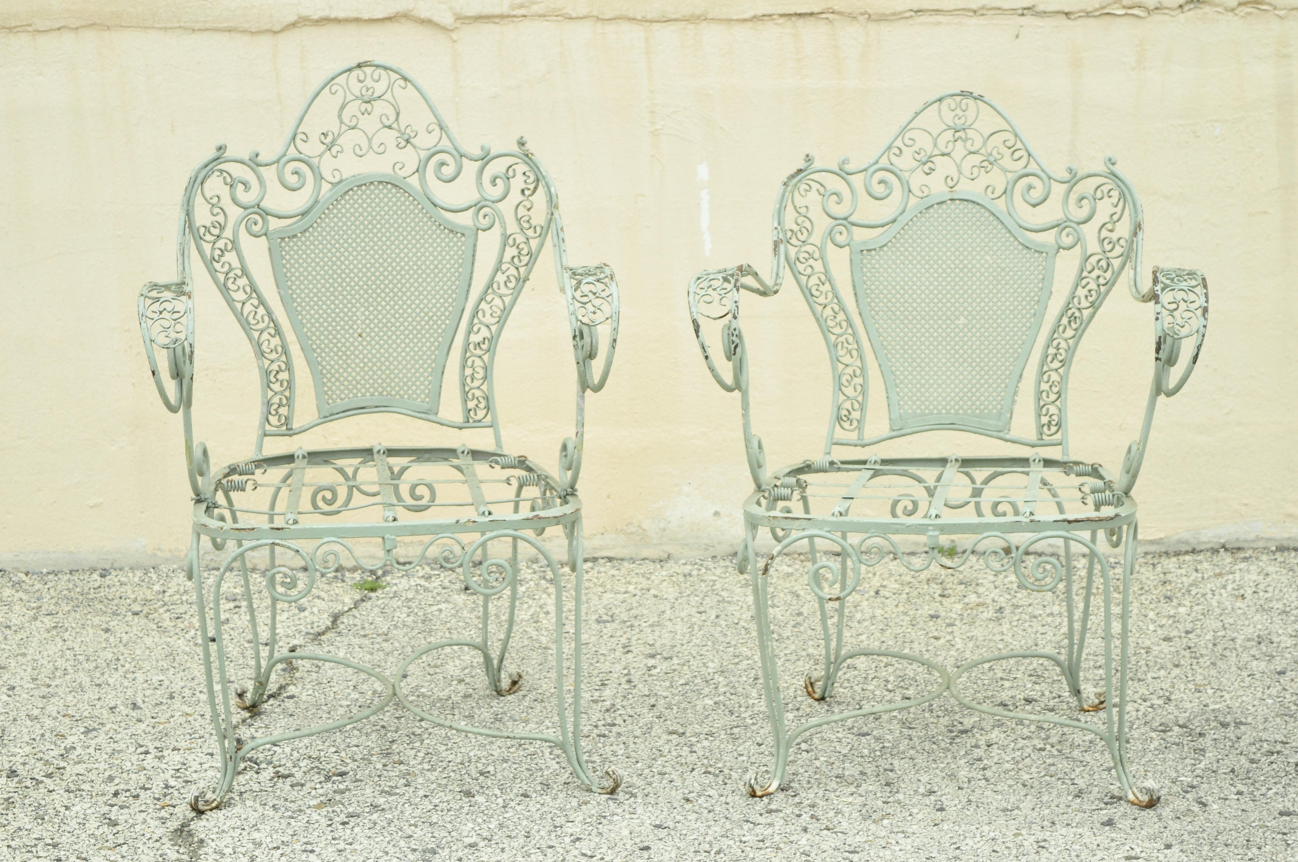 Vintage Salterini style green wrought iron scroll work garden patio arm chairs - a pair. Item features wrought iron construction, quality craftsmanship, great style and form. Believed to be Salterini but unconfirmed. Circa mid 20th century.