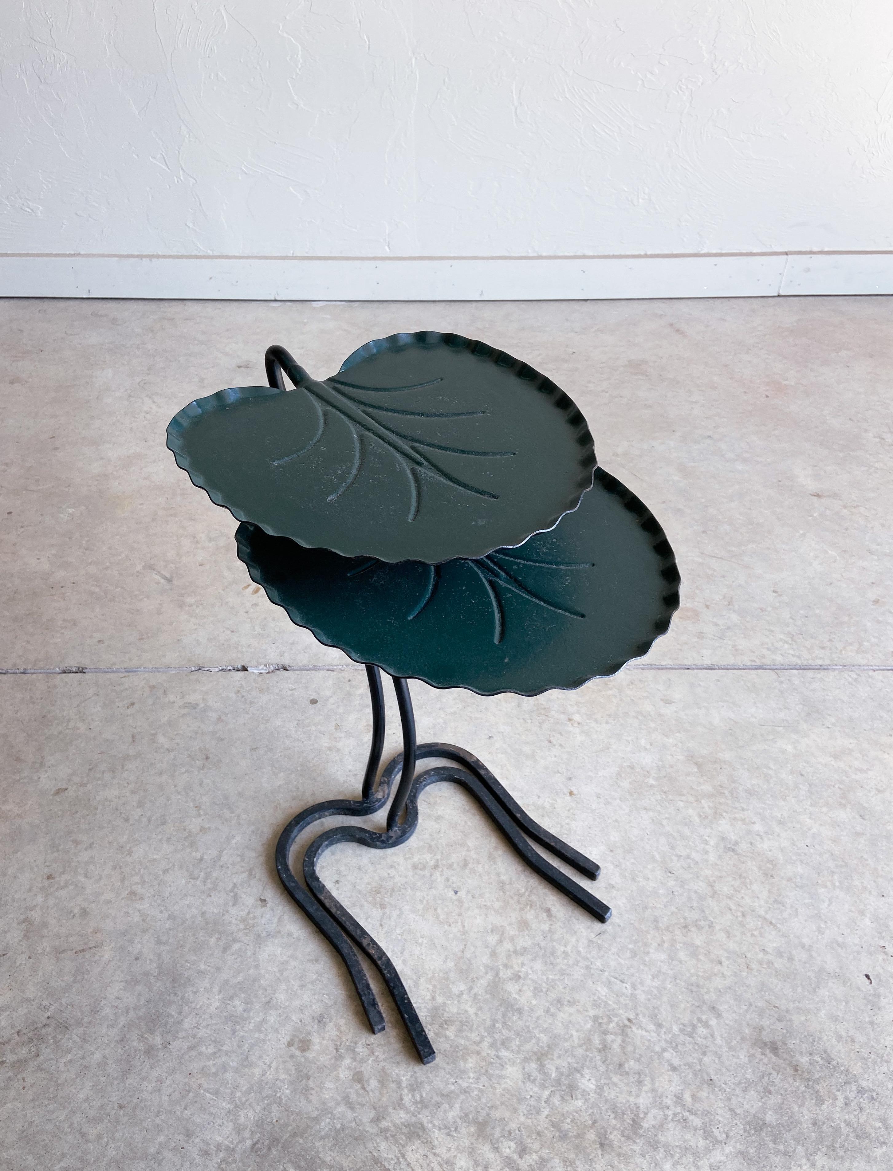 A fun and unique set of lily pad nesting tables by Salterini. Made from solid metal that has been formed, stamped, and welded. 

The original dark green finish is in great condition for its age. There is some finish loss and oxidation on the bases