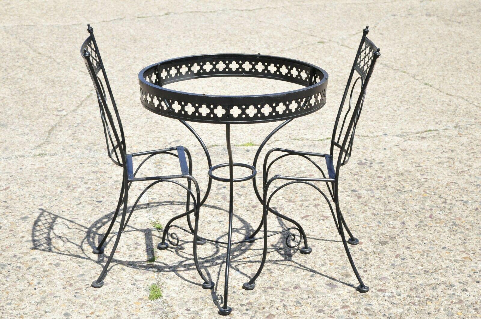 Vintage Salterini style wrought iron small garden patio bistro dining set - 3 piece set. Item features (1) small round dining table, (2) dining side chairs, pierced fretwork design to tables and chairs, wrought iron construction, very nice vintage