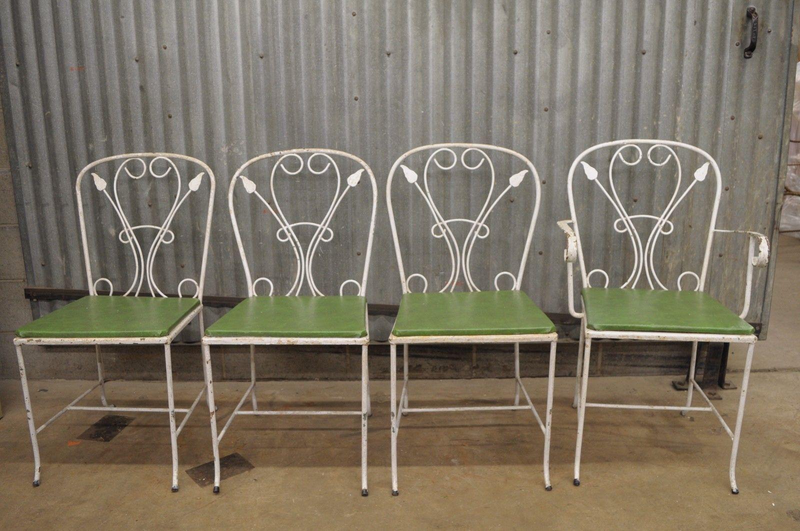 Vintage Salterini 5-piece wrought iron patio dining set, midcentury / Art Nouveau. Listing includes unique narrow rectangular table with glass top and stretcher base, 4 chairs (3 side chairs and 1 armchair), scrolling leaf / arrow pattern, wrought