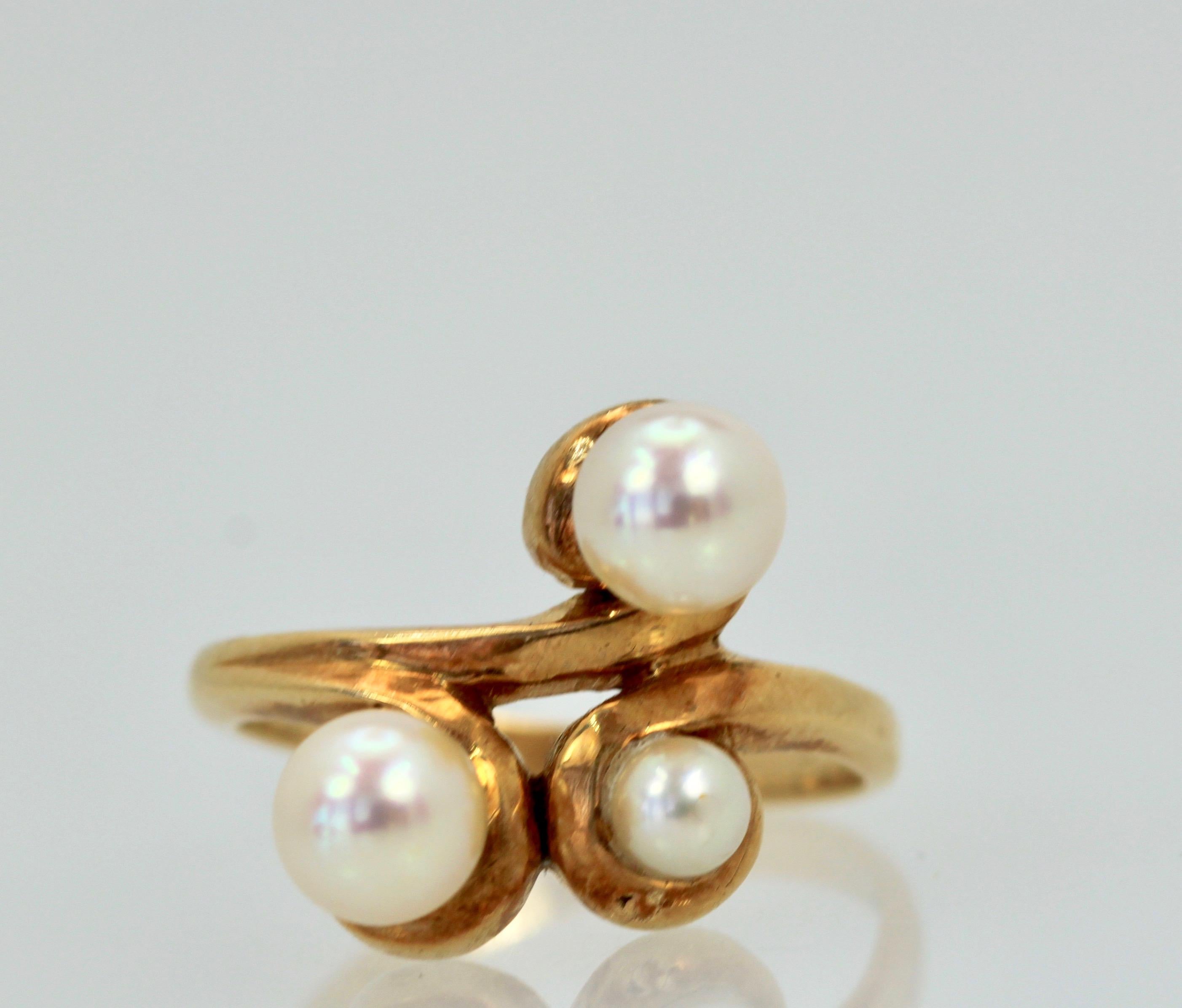 This vintage Saltwater Pearl Ring and Earring Suite is made from 14K Yellow Gold.  There are 3 Pearls on the Ring (2) are 4mm (1) is 2mm on a lovely gold mount.  The earrings hold 3 Pearls each of 4mm each in a clip pierced setting.  This set was