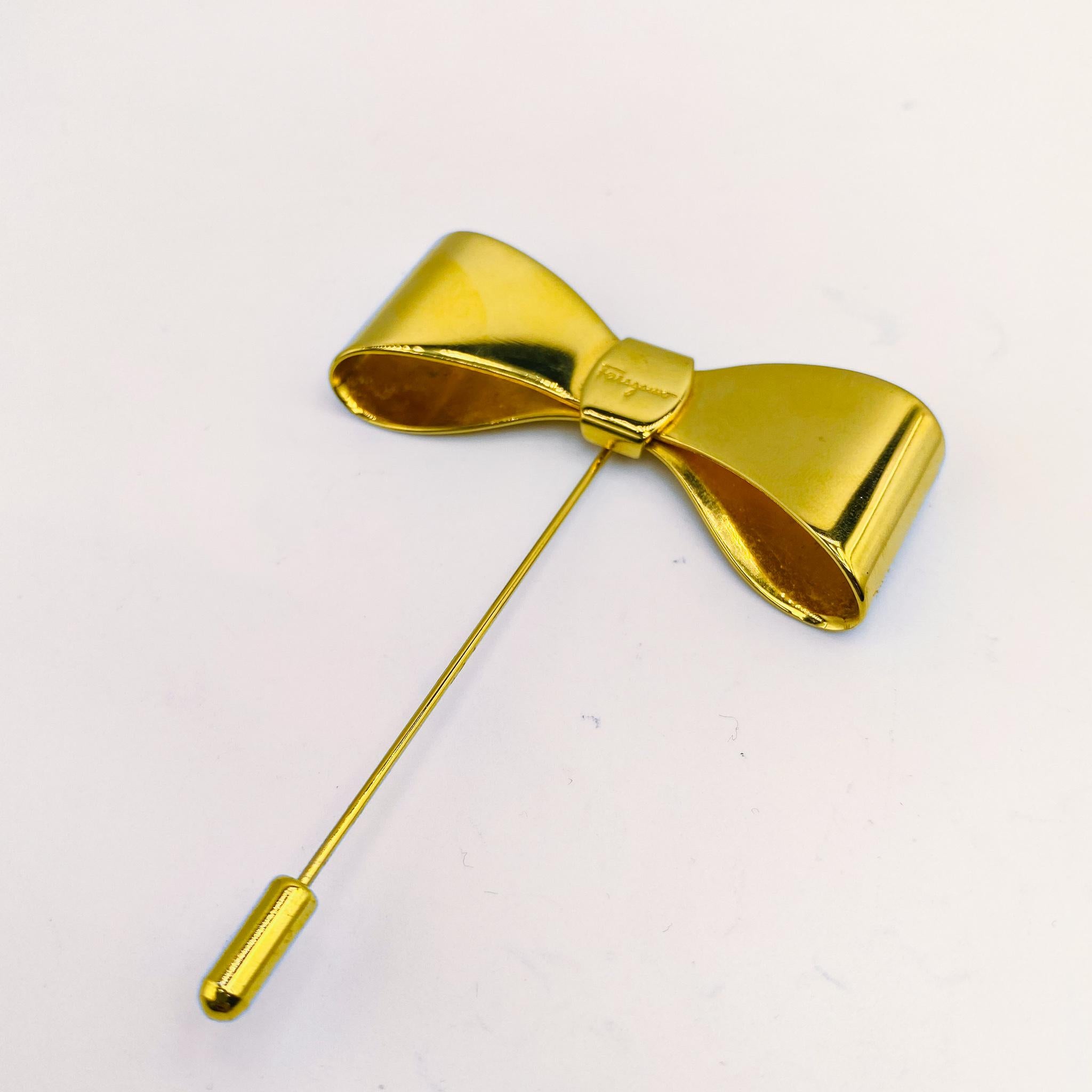 Vintage Salvatore Ferragamo Brooch 1990s

Gold plated brooch pin from the Italian designer Salvatore Ferragamo. Crafted in Italy from gold plated metal. Wear with your favourite jackets or shirts. 

Size & Fit
- 8.5cm long x 5.5cm wide

Authenticity