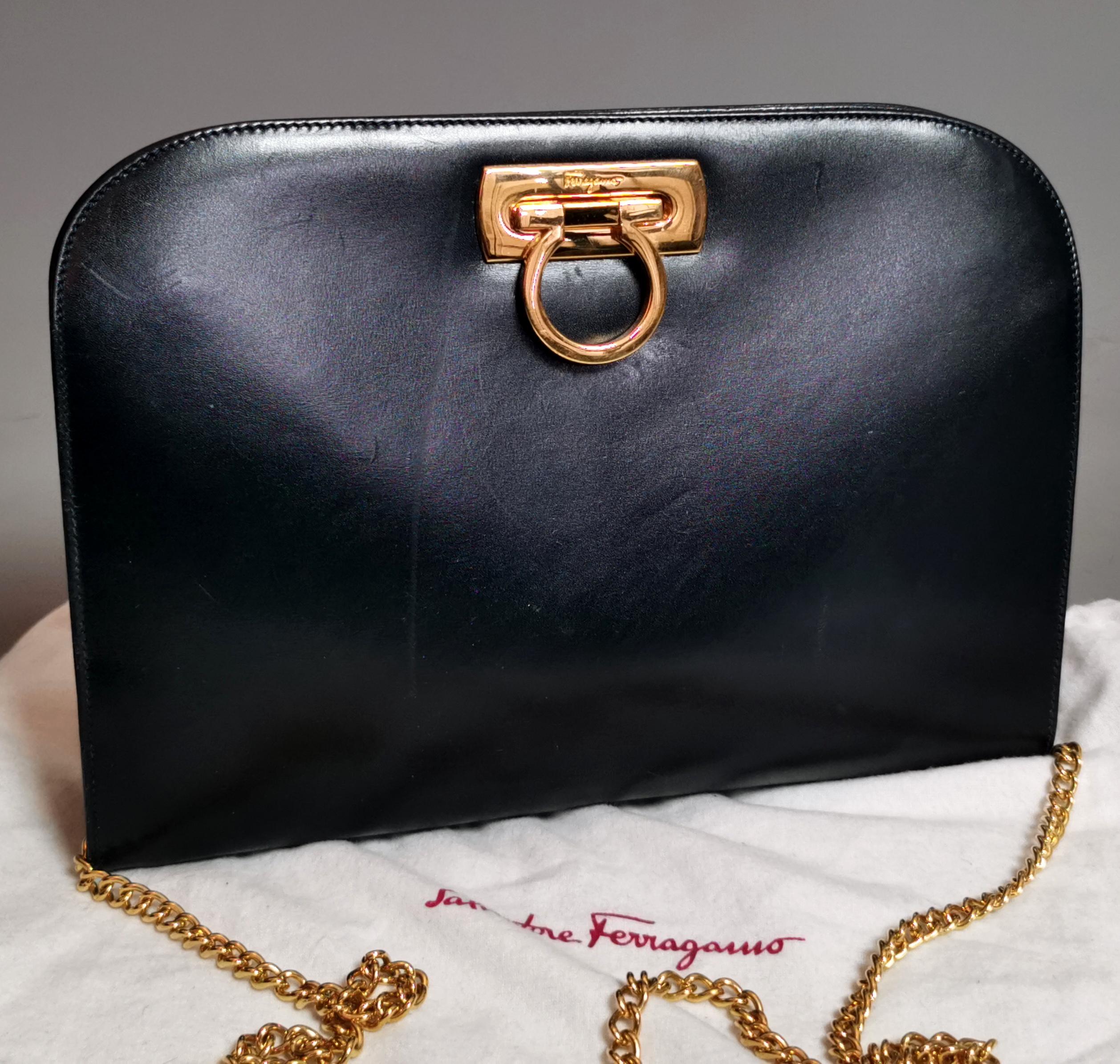 Vintage Salvatore Ferragamo Ganicini collection Crossbody bag.

This is a very versatile handbag and can be used as a clutch, crossbody or shoulder bag.

Made from Dark navy blue leather it has gold tone hardware and a long gold tone chain handle