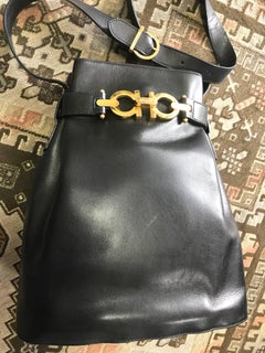 Vintage Salvatore Ferragamo navy leather hobo shoulder bag with gancini motif.