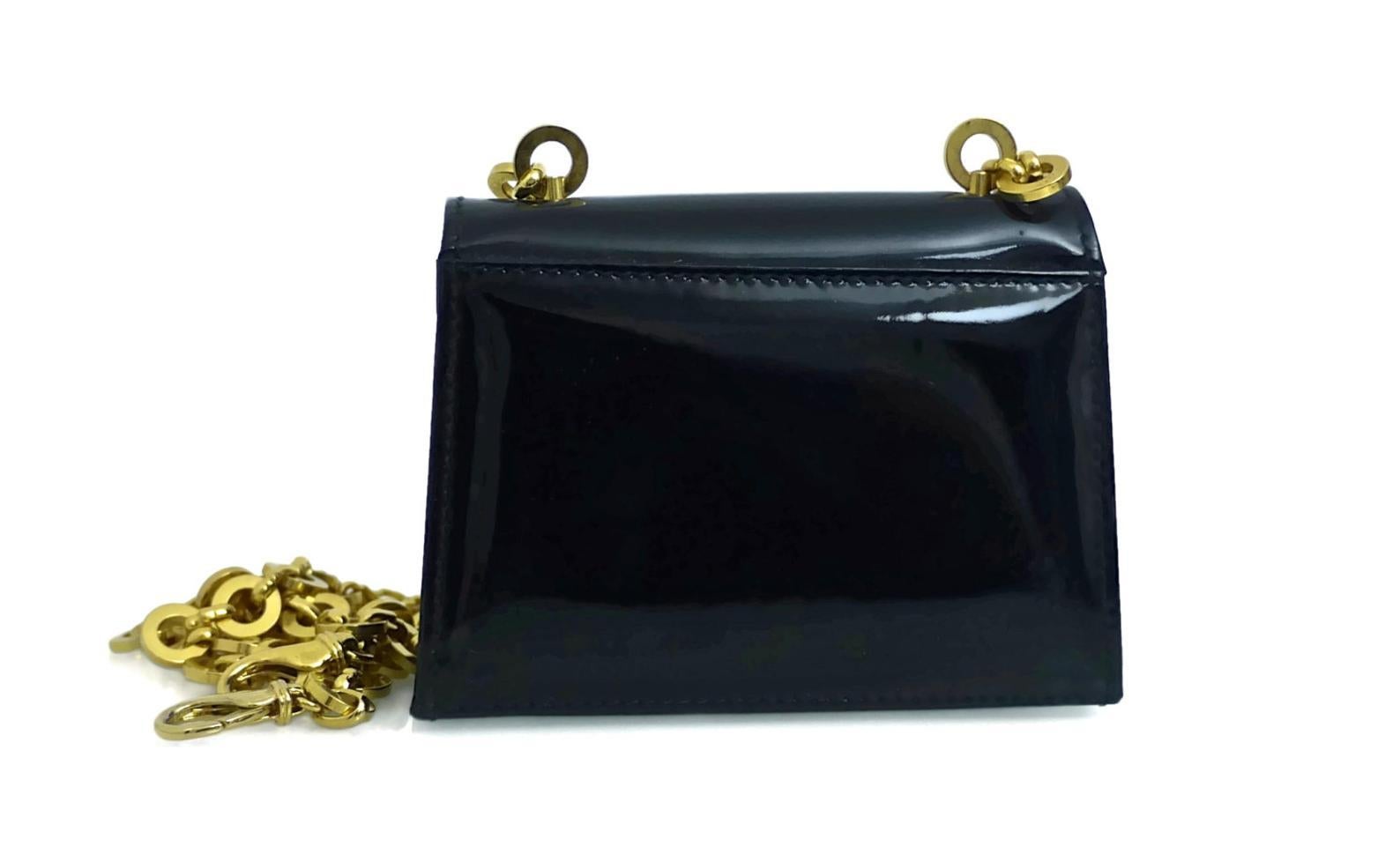 Vintage SALVATORE FERRAGAMO Patent Mini Shoulder Bag

Measurements:
Height: 3 2/8 inches
Width: 4 3/8 inches
Depth: 1 2/8 inches
Straps: 44 2/8 inches

Features:
- 100% Authentic SALVATORE FERRAGAMO.
- Black patent leather mini shoulder bag (minor