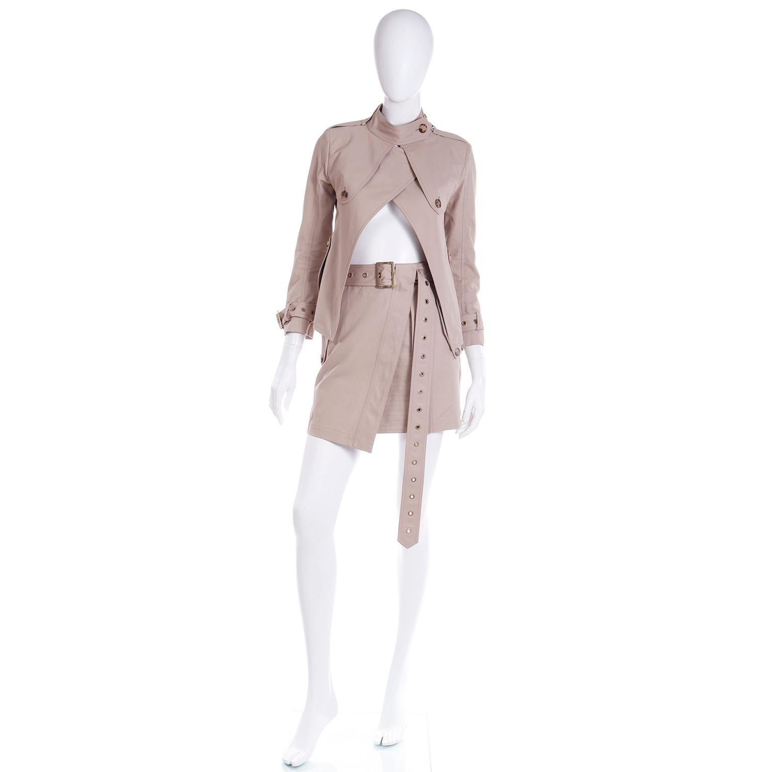 This unique vintage tan cotton outfit from Salvatore Ferragamo includes a cropped trench coat style jacket, a mini skirt and a long notched fabric belt with a Ferragamo branded buckle. The tan cotton fabric is so luxe and there is supple leather