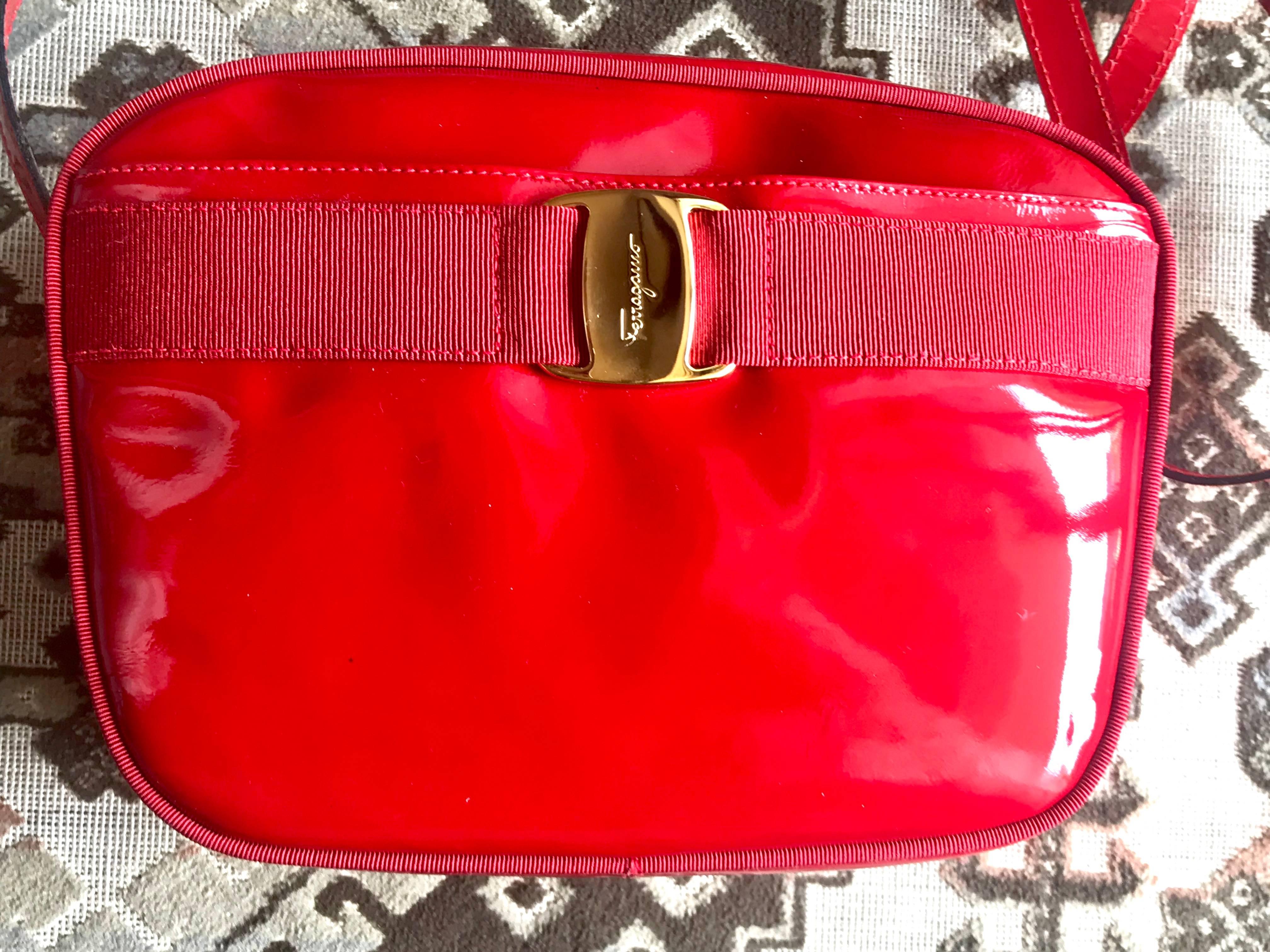 1990s. Vintage Salvatore Ferragamo vara collection patent enamel lipstick red shoulder bag with gold tone bow charm. Classic Ferragamo purse.

This is a vintage Salvatore Ferragamo Vara red patent enamel shoulder bag from the 90s. Rare color in sexy