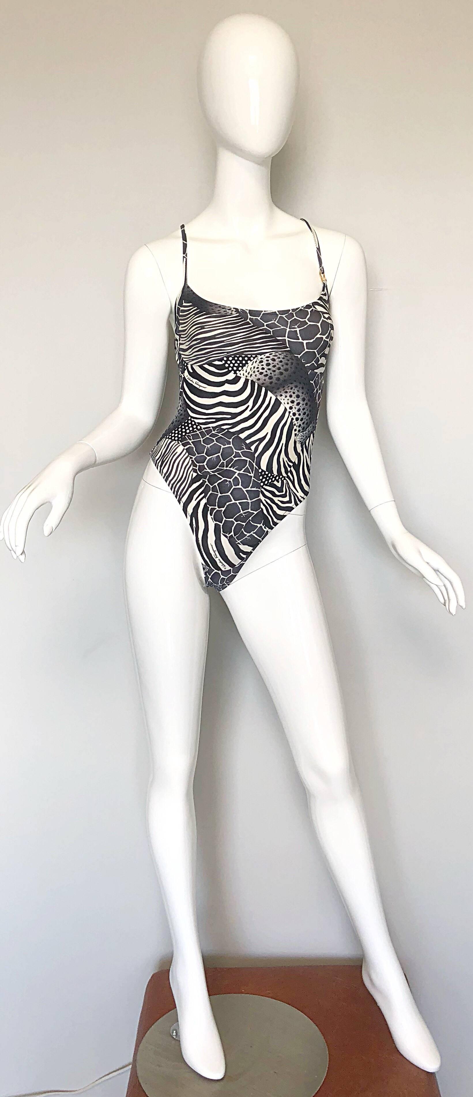 Sexy, yet classic 90s SALVATORE FERRAGOMO black and white animal print one piece swimsuit OR bodysuit! Features chic print of leopard, zebra and giraffe throughout. Signature gold Ferragomo embossed horsebit at left front strap. Sexy low cut back.
