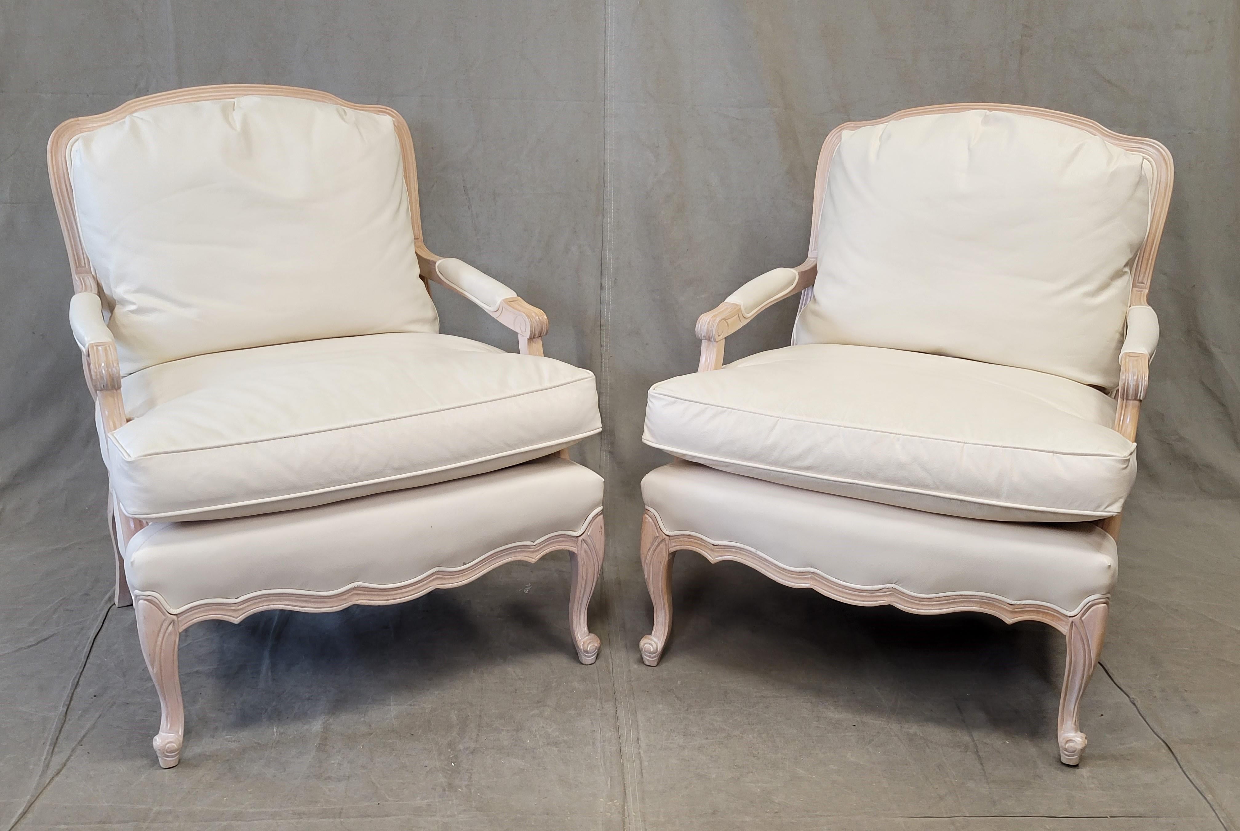 A beautiful, classic set of vintage 1990s Sam Moore white washed maple wood frame bergere chairs with custom upholstery in ivory grain leather (not bonded leather, not faux leather), see second to last photo. See photo of white computer paper on the
