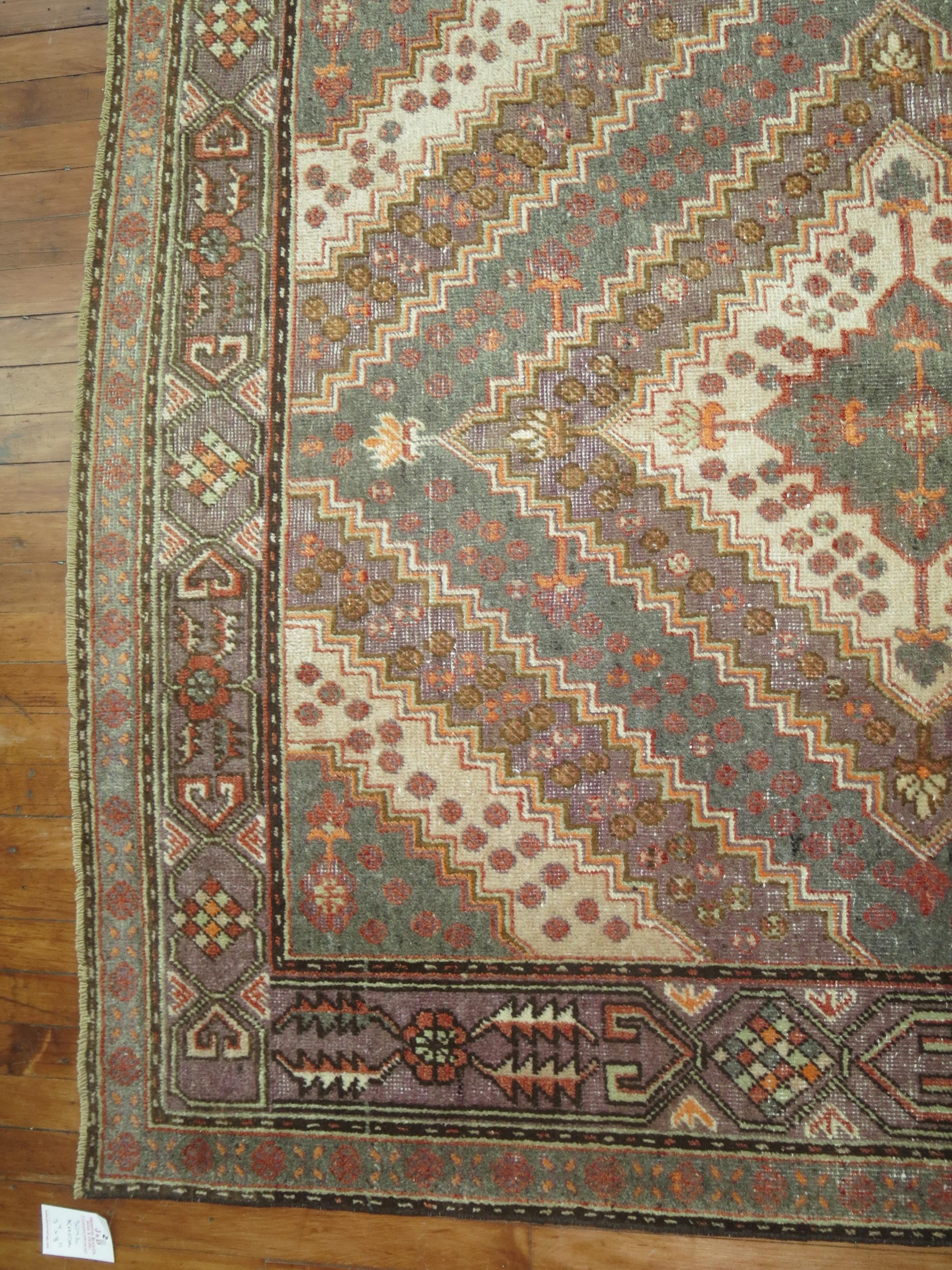 A vintage East Turkestan Samarkand rug in gray, lavender and apricot 

Measures: 5'4'' x 8'11''.