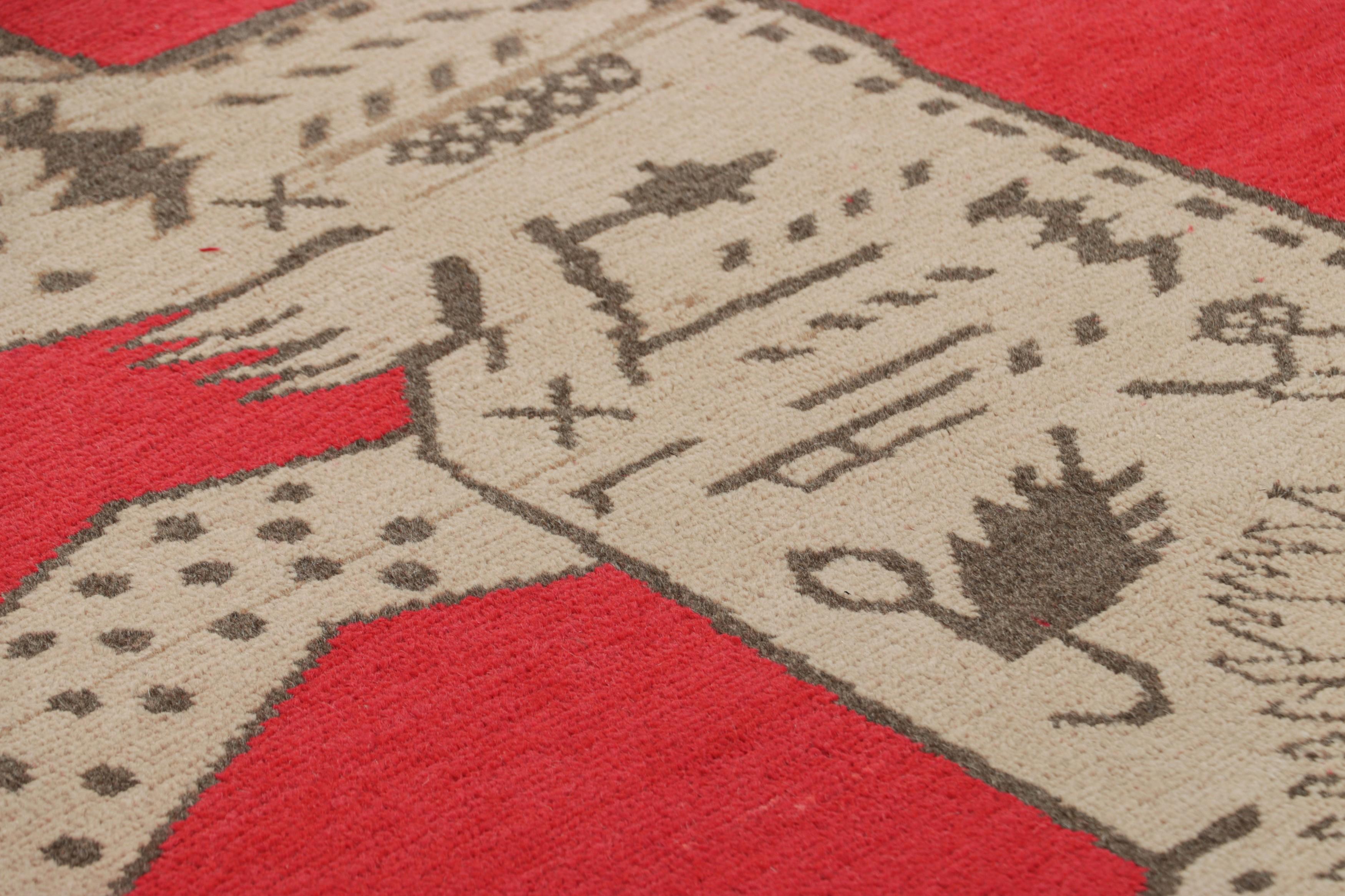 Made with hand-knotted wool and originating from East Turkestan circa 1930-50, this 4x7 Samarkand rug is an exciting entry to Rug & Kilim’s repertoire of Vintage Oriental creations, featuring a stylized lion motif in beige atop a rich vermilion-red