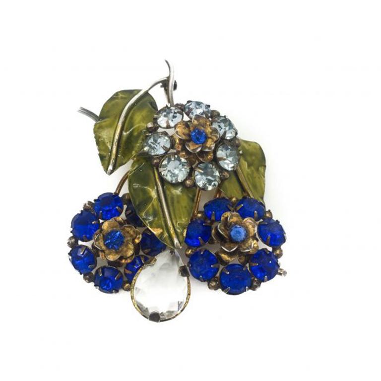 Sandor jewels are increasingly rare and these early Sterling Silver Sandor Flower Brooches created in the 1940s are especially so. This is a delightful floral vintage Sandor brooch featuring early paste stones of a delicate pale blue and contrasting