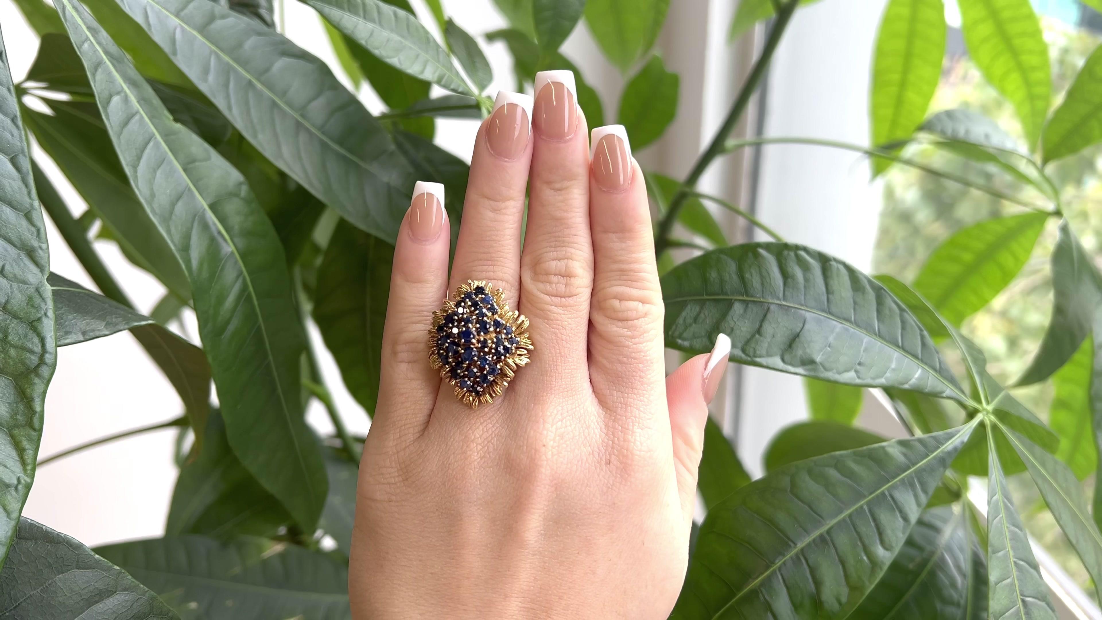 One Vintage Sapphire 18 Karat Gold Cluster Statement Ring. featuring 35 round sapphires with a total weight of approximately 4.50 carats. Crafted in 18 karat yellow gold with purity marks. Circa 1970s. The ring is a size 7 and may be resized.