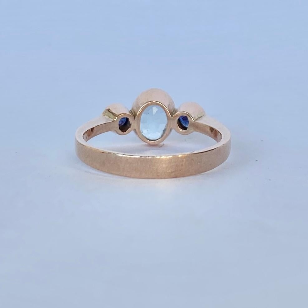 This ring holds an aqua at the centre measuring 75pts and either side are sapphires measuring 15pts each. Modelled in 9carat gold. 

Ring Size: O or 7 1/4 
Width: 8mm

Weight: 2.6g