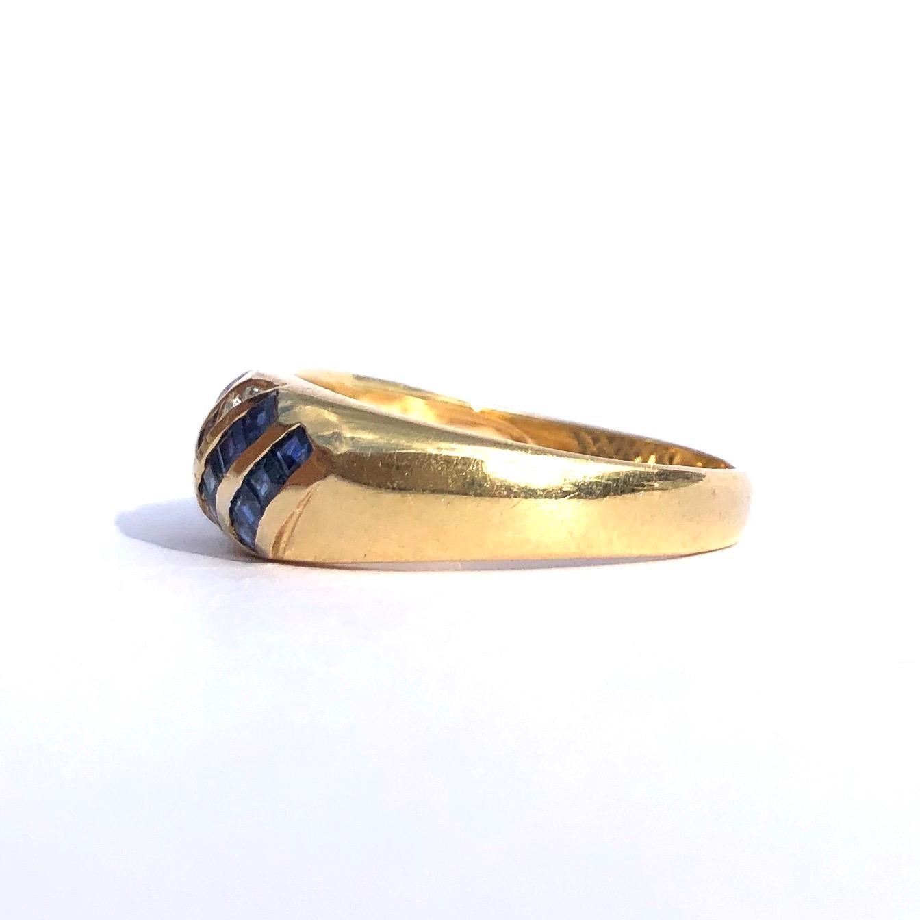 This 18ct gold band is encrusted with square cut sapphires and four round cut  diamond points. The 5pt sapphires make up six neat lines and have a wonderful glitter as it moves in the light. Made in London, England. 

Ring Size: M or 6 1/4
Band