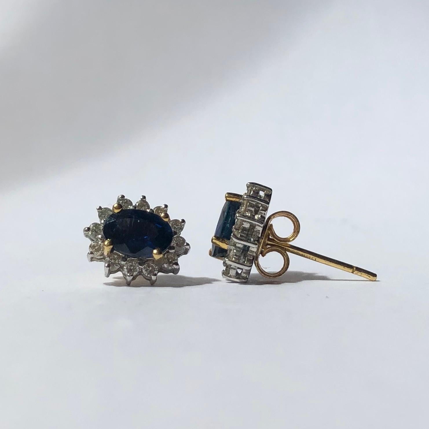 This pair of exquisite earrings each hold a deep blue sapphire measuring 50pts and the gorgeous stones are surrounded by a halo of diamond. Each diamond measures 2pts each. When the sunlight hits the sapphires there is a bright blue hue that can be