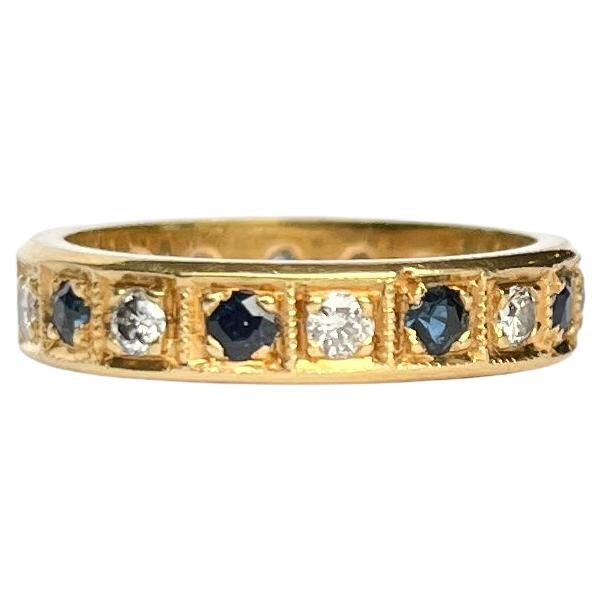 Set within this 18ct gold band there are nine deep blue sapphires and nine sparkling diamonds. The stones measure 5pts each. 

Ring Size: L or 5 3/4
Band Width: 4mm

Weight: 4.3g 
