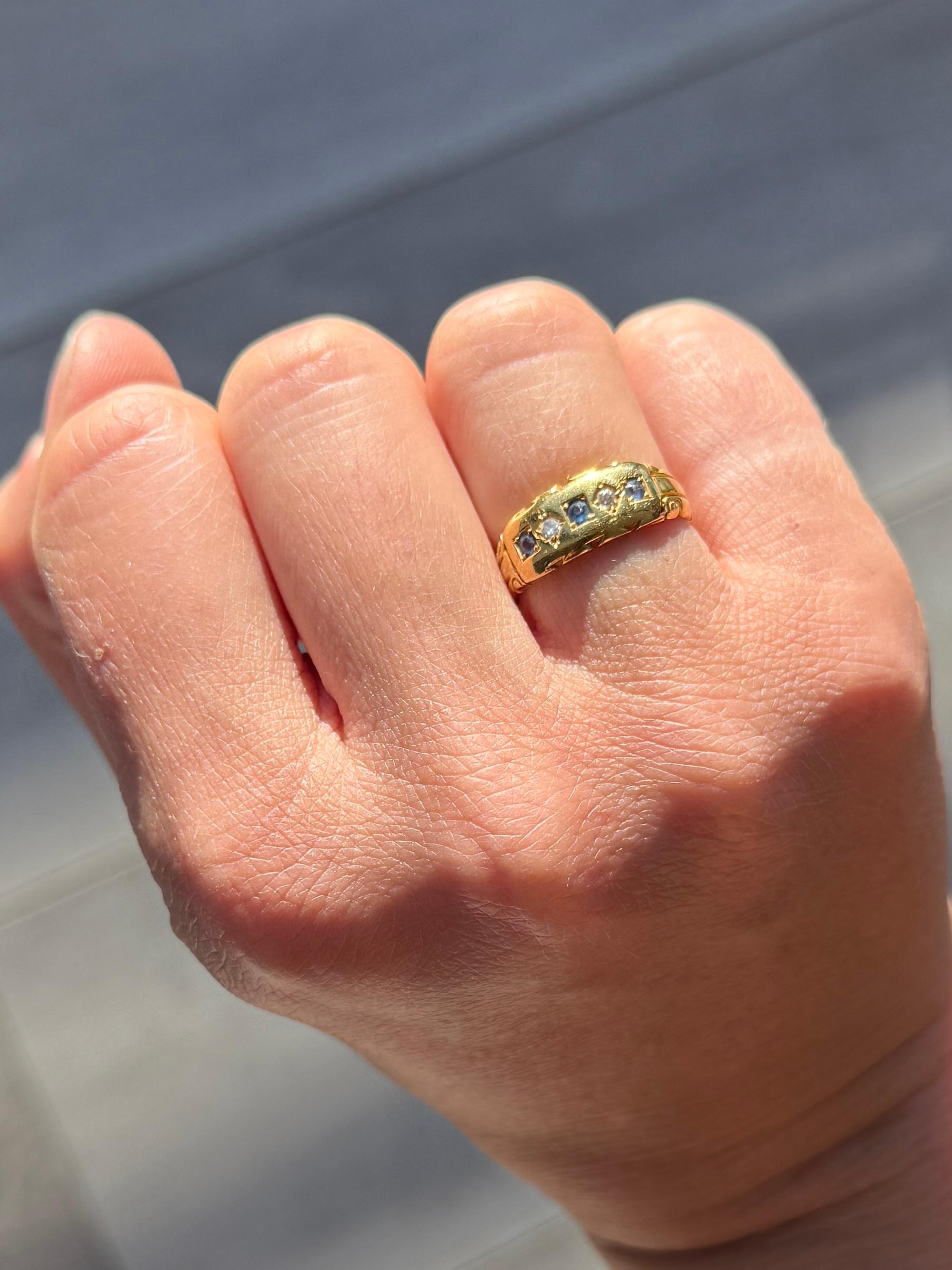 Set within the gold there are three bright blue and gorgeous sapphires totalling approx 15pts. Sat between the sapphires are two bright diamonds. The diamond total 8pts . The ring is modelled in 18ct gold.

Ring Size: I or 4 1/4 
Band Width: 7mm