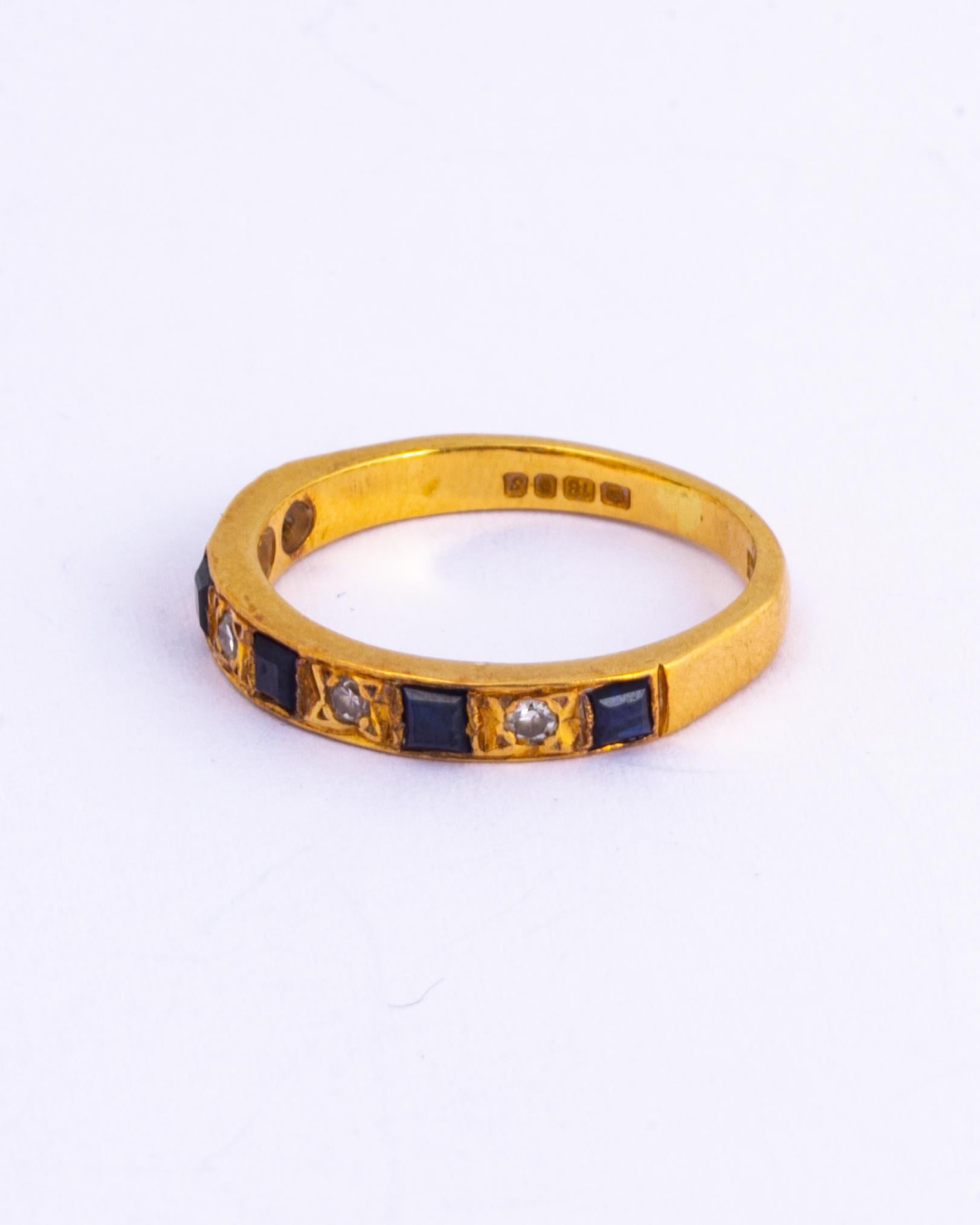 Set within this 18ct gold band there are five deep blue sapphires and four sparking diamond points. The sapphires are square cut and measure 10pts each. 

Ring Size: K or 5 3/4 
Band Width: 2.5mm

Weight: 2.8g 