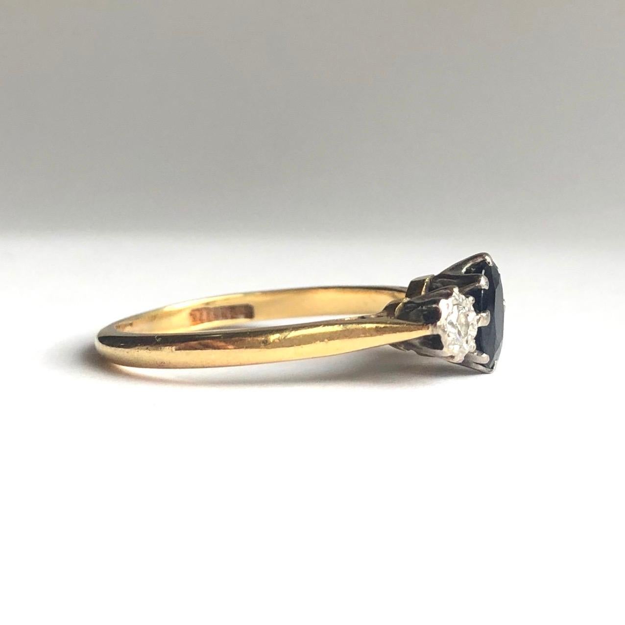 Sat in-between two 7pt diamonds is a 70pt deep blue sapphire. The diamonds are bright and sparkly and the stones are all set in platinum with the rest of the band modelled in 18ct gold. 

Ring Size: N 1/2 or 7 
Widest Point: 7mm
Height Off Finger:
