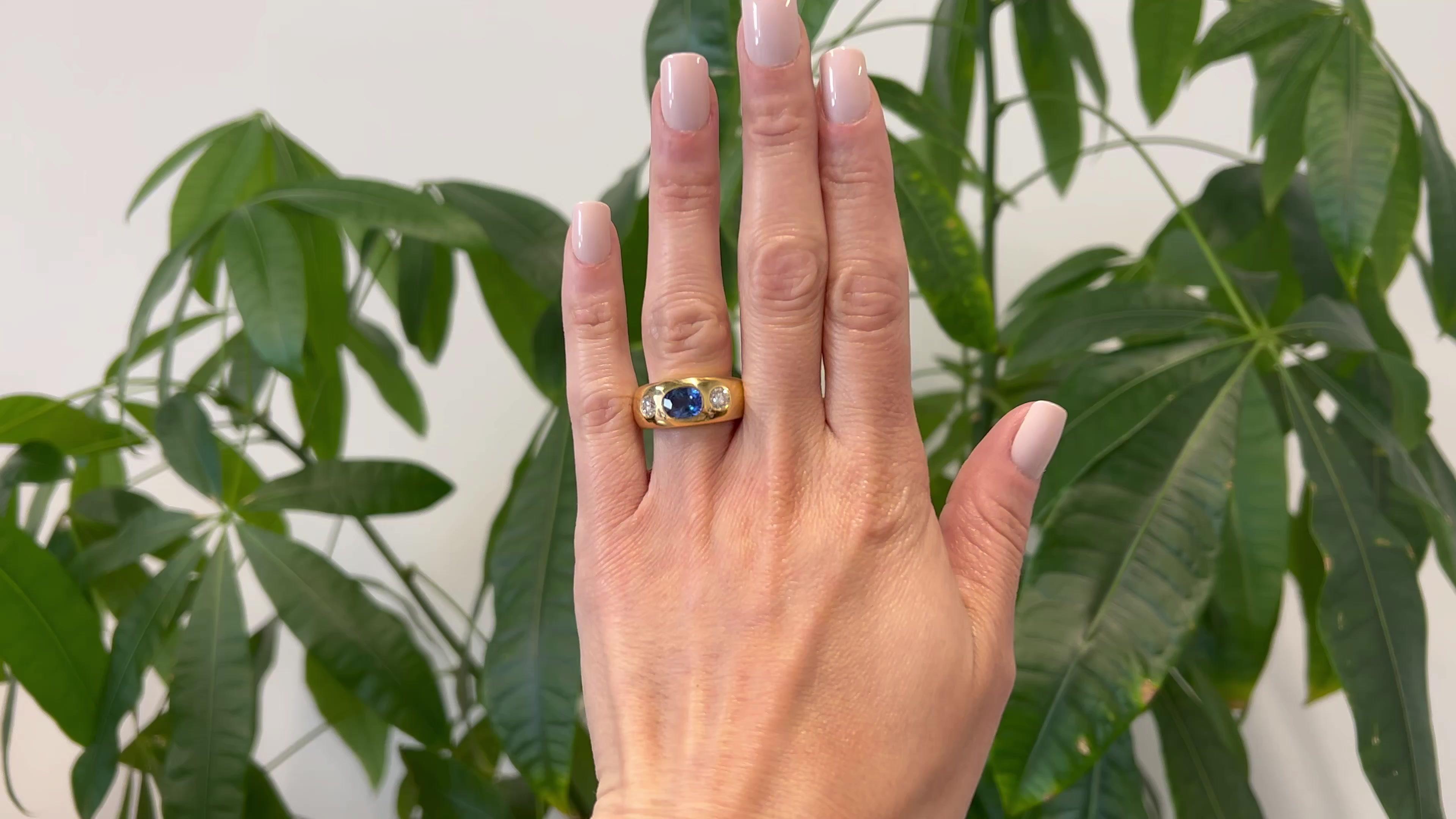 One Vintage Sapphire and Diamond 18k Yellow Gold Three Stone Ring. Featuring one cushion cut sapphire weighing approximately 1.75 carats. Accented by two round brilliant cut diamonds with a total weight of approximately 0.85 carat, graded F color,