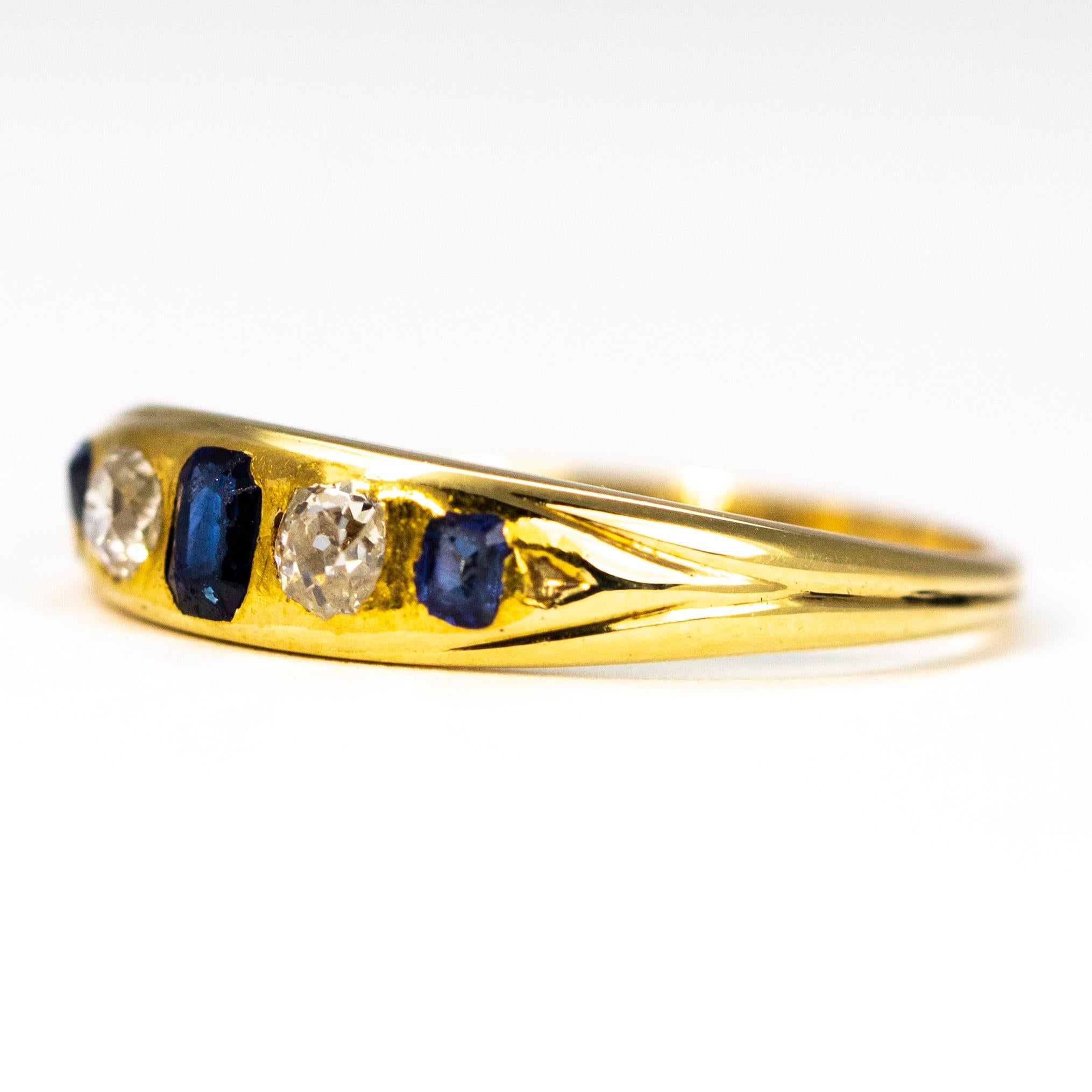 This five stone gold band holds a central sapphire measuring 15pts and the two smaller stones measure 7pts each. The two old mine cut diamonds that sit in-between these gorgeous blue stones measure 10pts each. 

Ring Size: M or 6 1/4
Band Width: