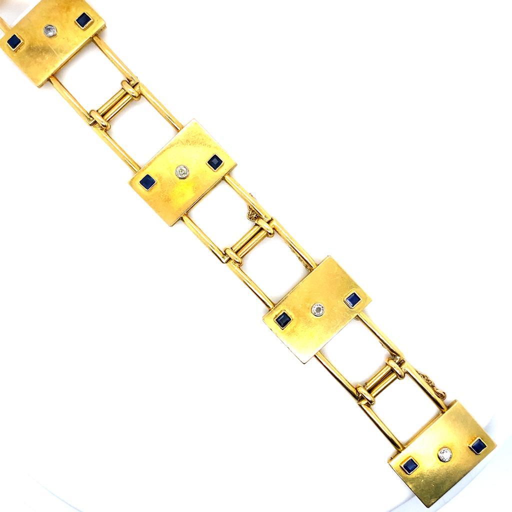 A vintage sapphire and diamond bracelet in 18 karat yellow gold, circa 1930.

Designed as a series of four bold yellow gold rectangular panels, each bezel set with an old cut diamond of 0.05cts to its centre offset with two square cut sapphires at