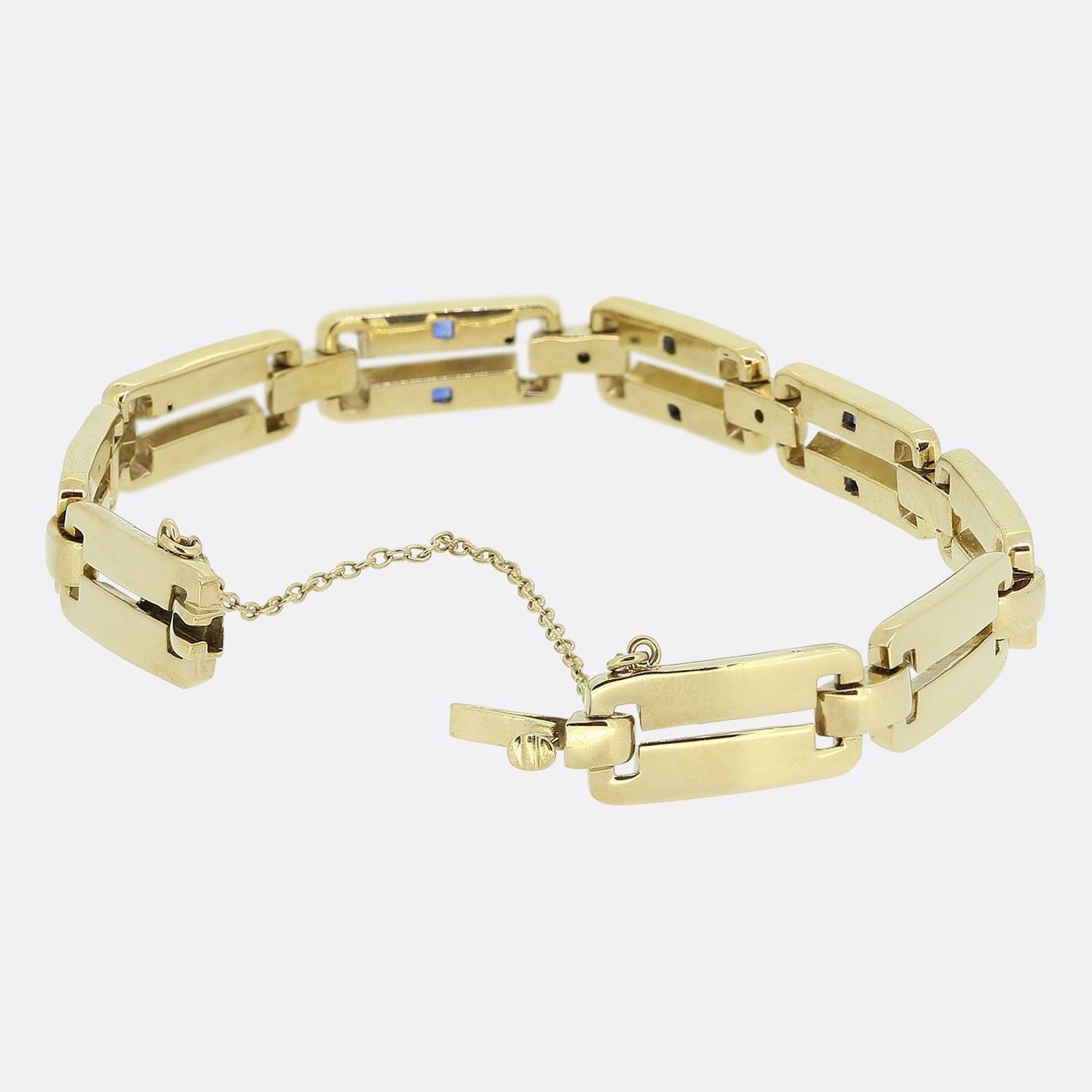 Here we have a versatile vintage bracelet. It consists of sleek 14ct gold rectangular open links, the front three of which have each been adorned with a duo of rub-over set square sapphires and connected by old cut diamond set circular prism shaped