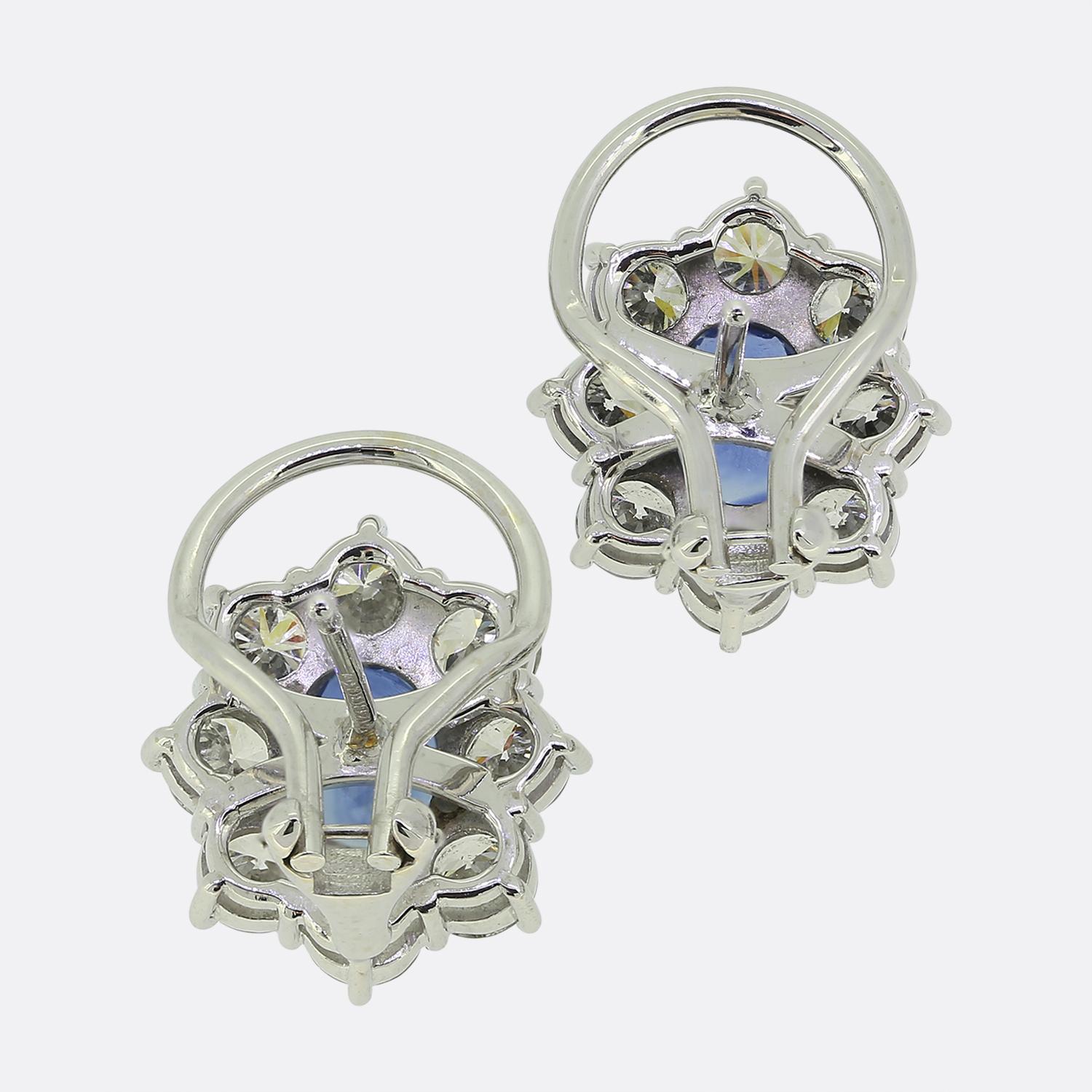 Here we have a truly stunning pair of sapphire and diamond cluster earrings. Each earring plays host to a mid to dark blue sapphire which is surrounded by eight sparkling round brilliant cut diamonds. 

Condition:Used (Excellent)
Total Weight: 9.0
