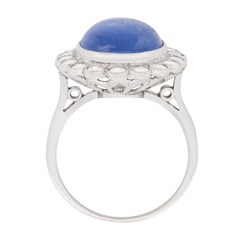 This beautiful Sapphire and Diamond cluster ring is a great example of vintage jewellery. The Sapphire is an Oval cabachon cut, with a carat weight of 9.20. It is surrounded by high quality diamonds, colour grading G and clarity VS. They have a