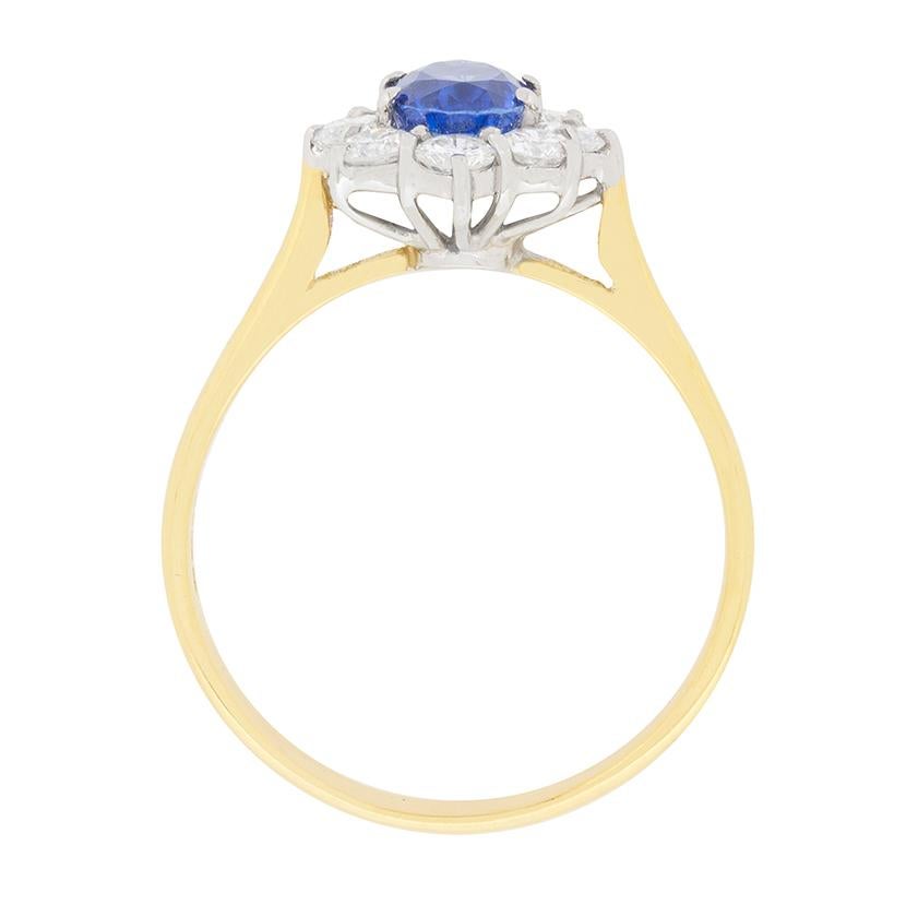This beautiful vintage Garrard ring boasts a centre Sapphire weighing 1.14 carat. It is a rich, deep blue and complimented wonderful by a halo of diamonds. The diamonds are round brilliants and their total carat weight is 0.80 carat. 

They sparkle