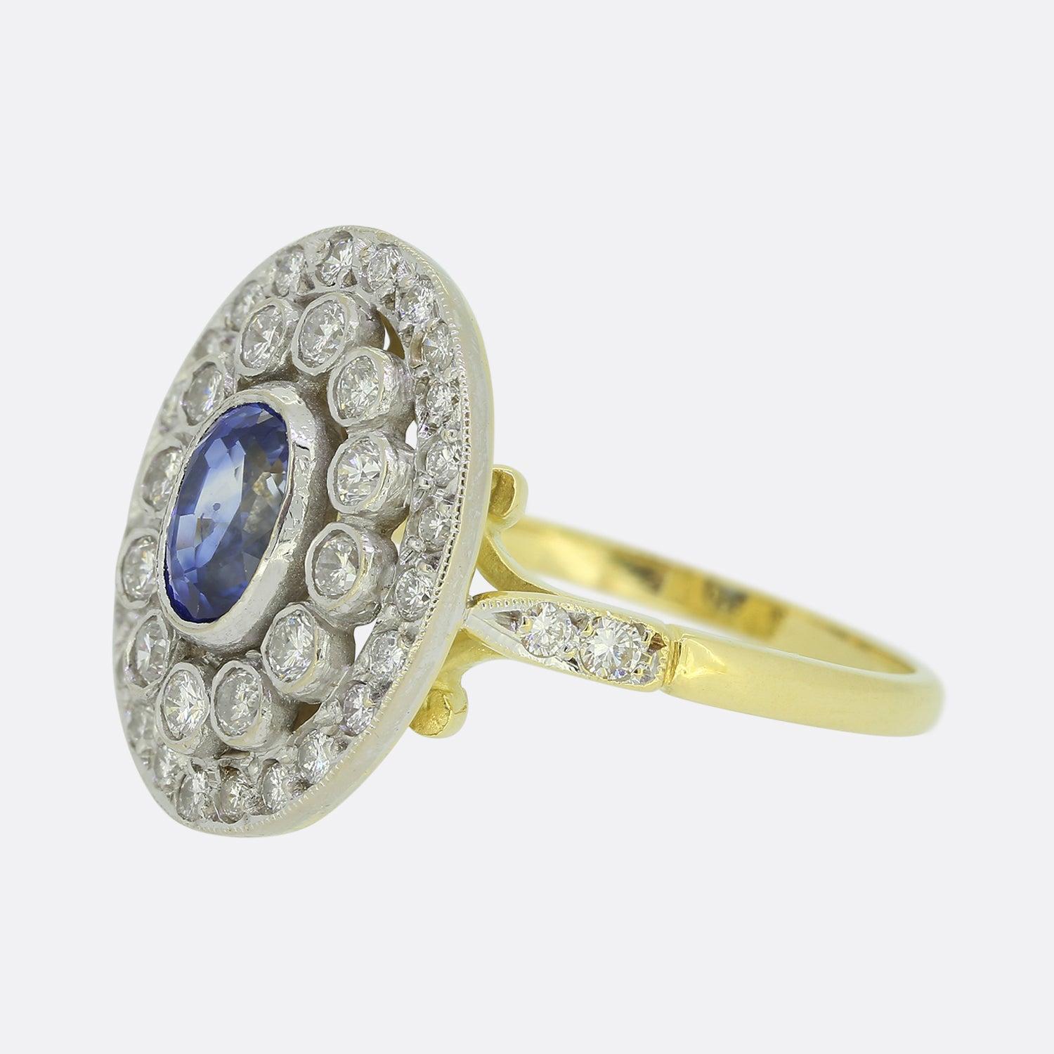 Here we have a stunning sapphire and diamond cluster ring. An open multi-layered structure plays host an oval shaped sapphire at the centre which possesses a strong vivid blue colour tone. This focal stone is then surrounded by two circulating rows