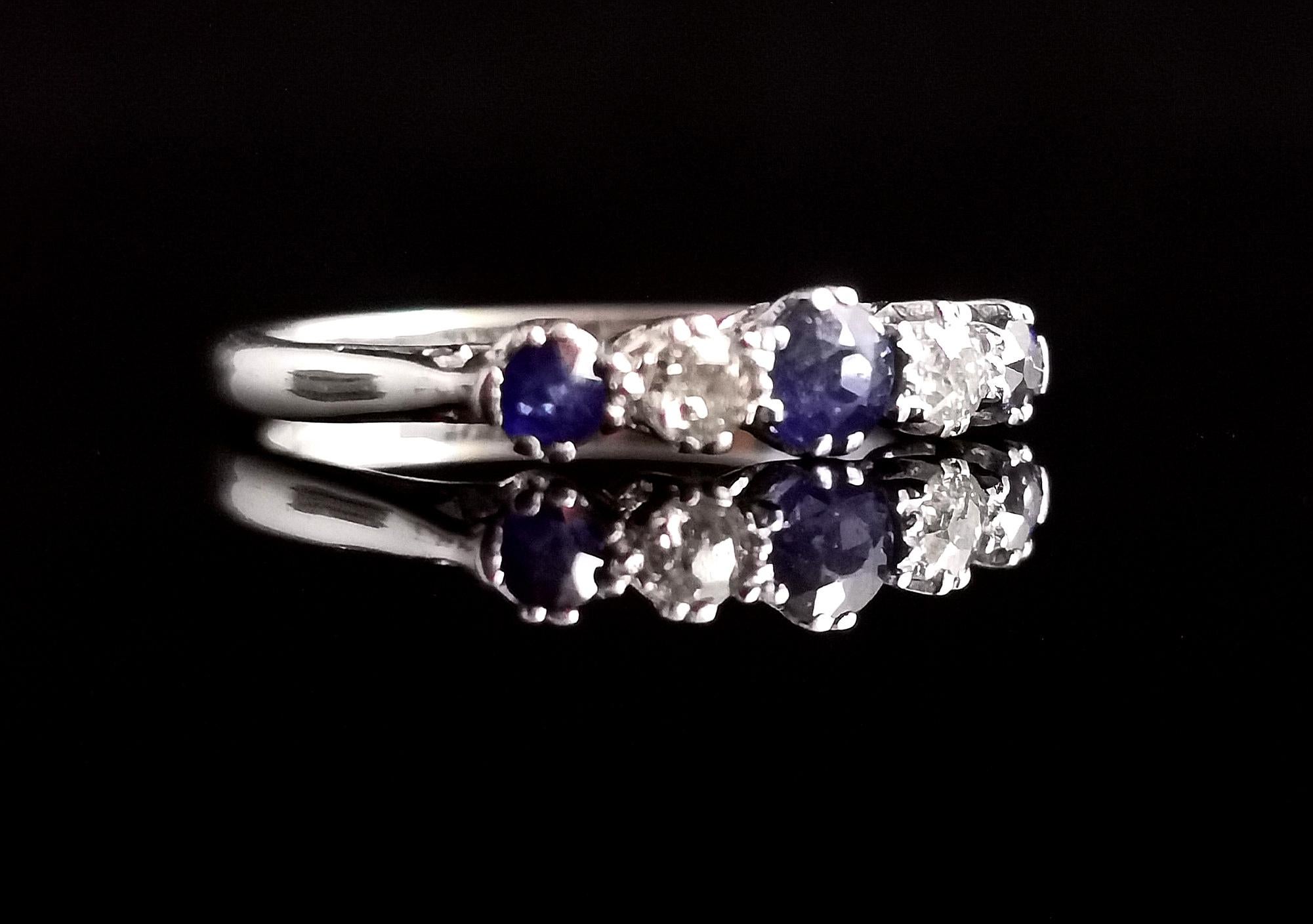 A stunning vintage, mid century, c1940s, Sapphire and Diamond half hoop ring.

The ring has a lovely D profile, high polish 18 karat white gold band with a platinum half hoop setting.

The setting features a beautiful rich blue central round cut