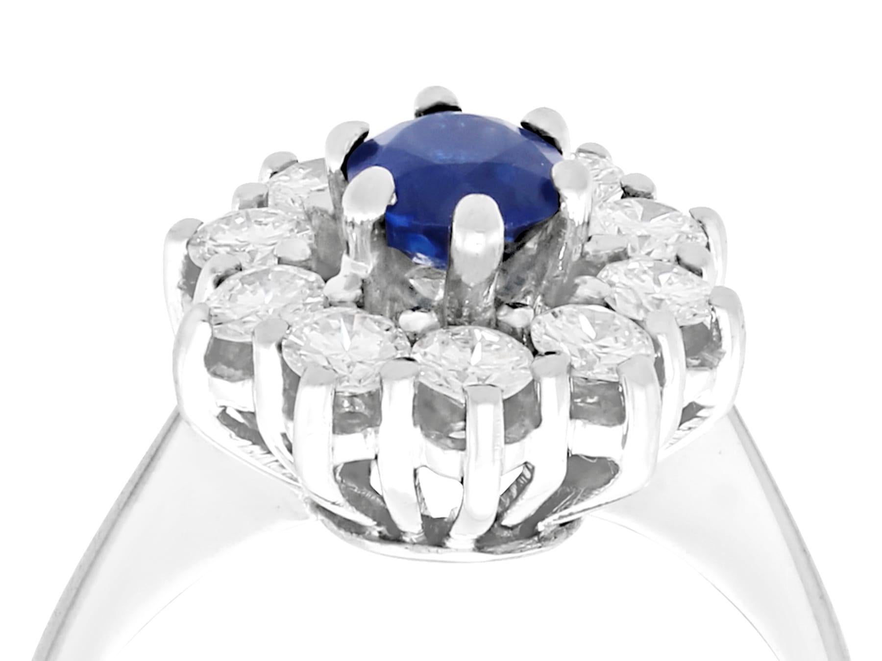 A fine and impressive 0.46 carat natural blue sapphire and 0.45 carat diamond (total), 18 karat white gold cluster ring; part of our vintage jewelry and estate jewelry collections.

This fine and impressive vintage sapphire and diamond cluster ring