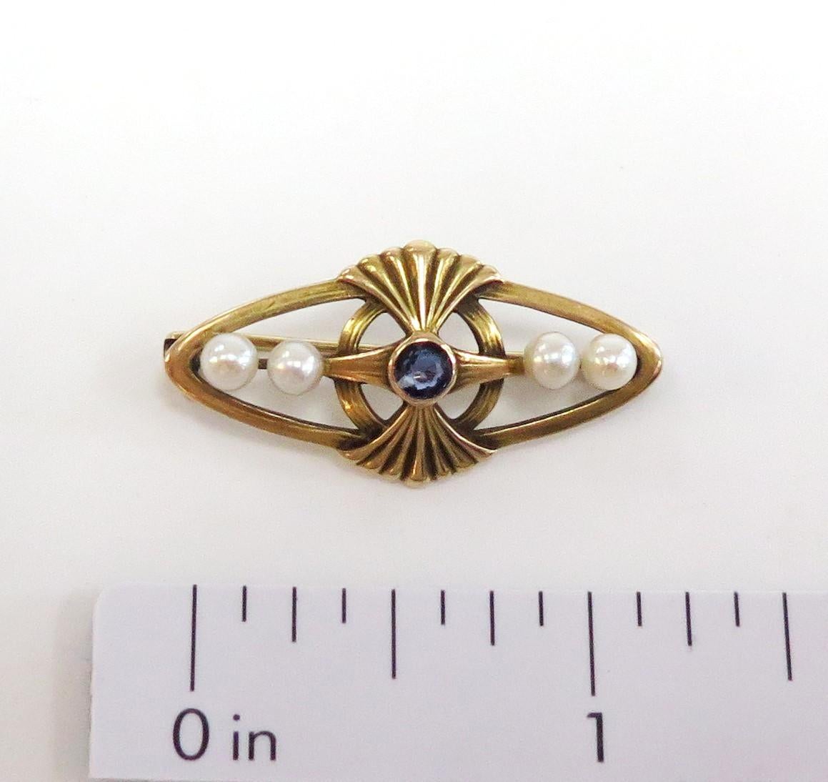 This Vintage Bar Pin (circa 1920 / Art Nouveau era) has one larger center bezel set Sapphire and two 3.5mm cultured pearls on each side of it. It has the very familiar fan shaped art nouveau design above and below the center stone. The measurements