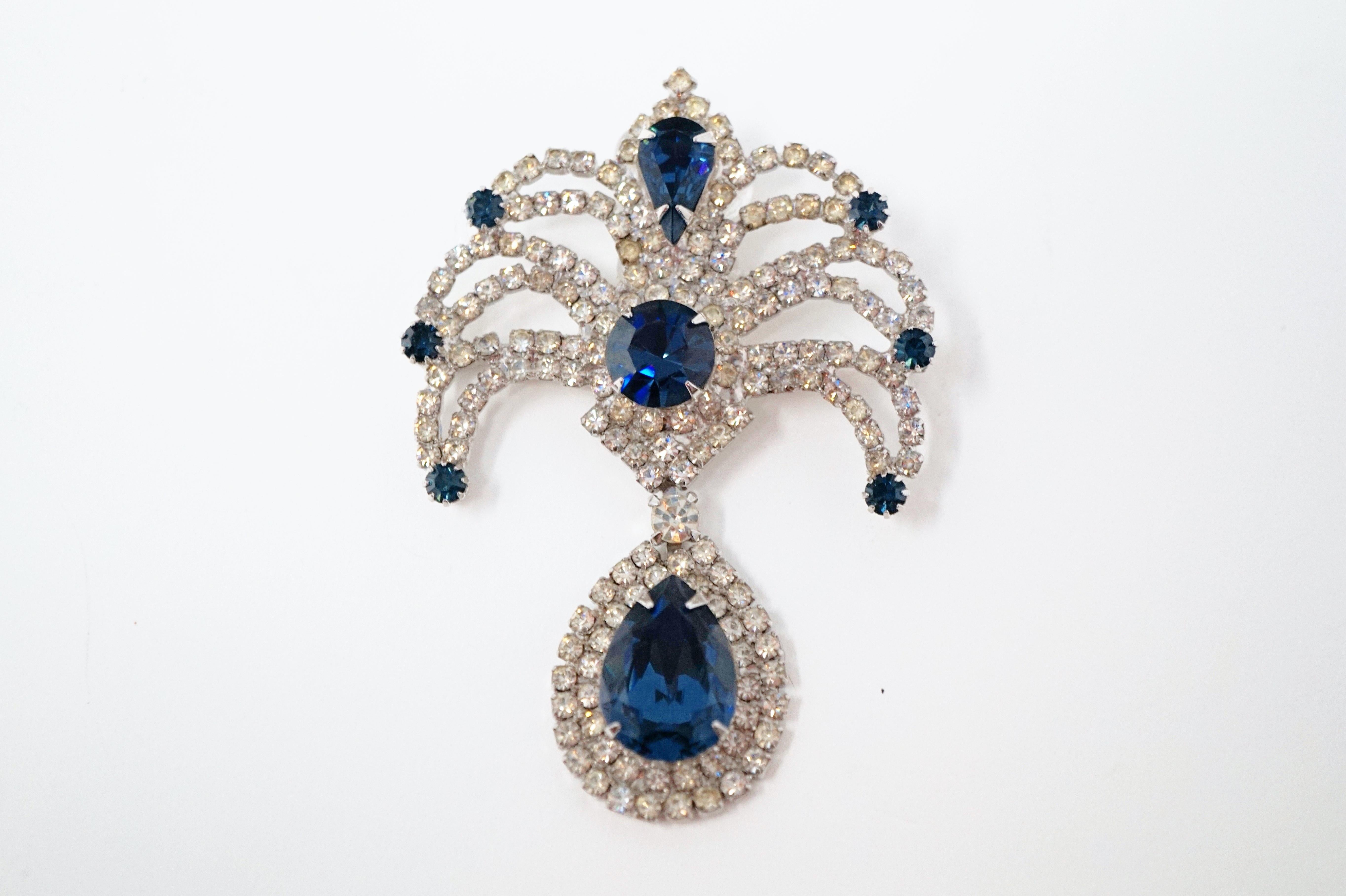 Absolutely gorgeous sparkling rhinestone brooch from the mid-century era, featuring prong set faceted Sapphire-colored crystal rhinestones surrounded by clear crystal rhinestone pavé with silver tone hardware.

DETAILS:
- Silver tone
- Approx 2