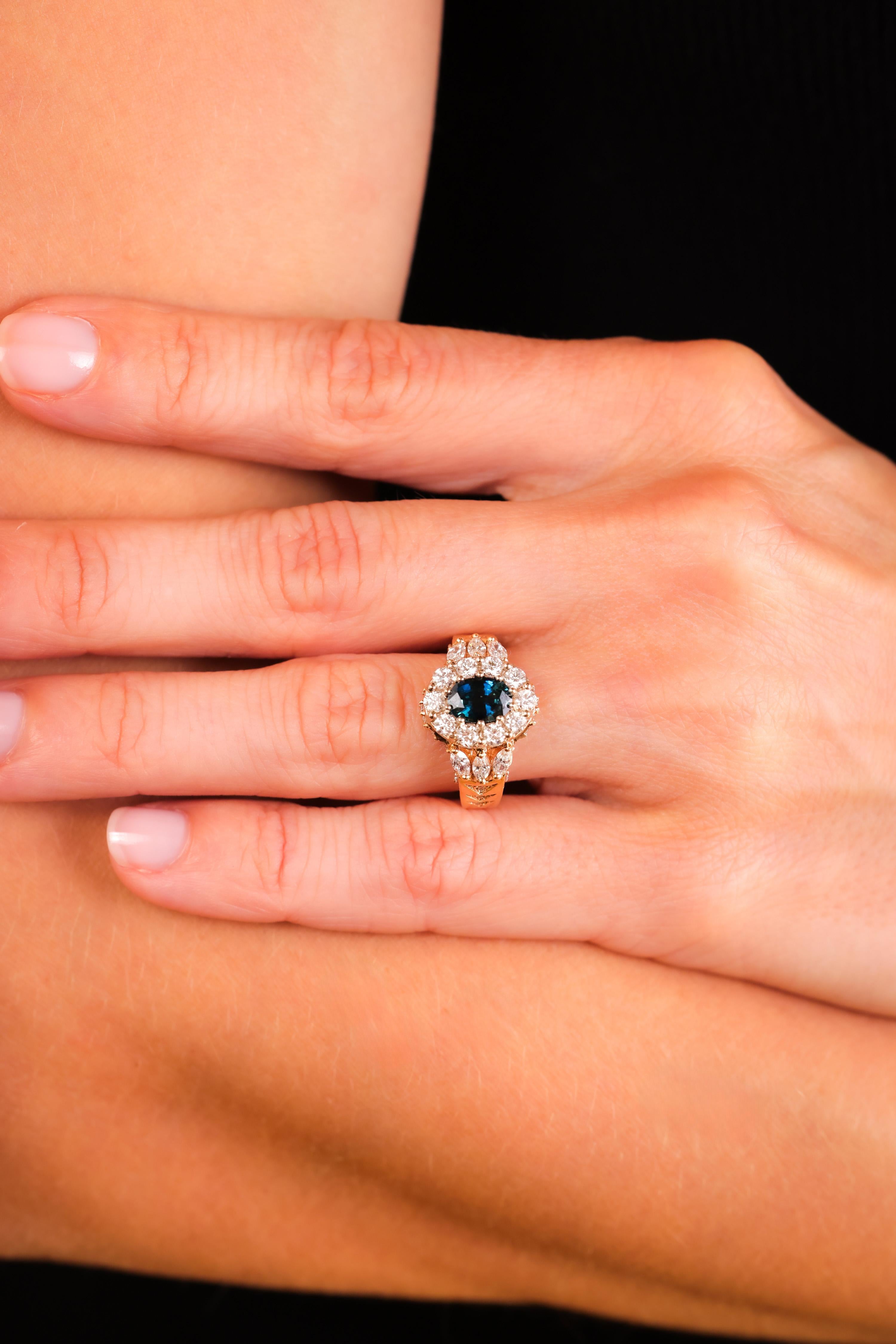 Center Stone: Sapphire 
Cut: Oval
Weight: Approximately 1 Carats
Color:Blue
Accent Stone: 40 Diamonds
Cut: Round Brilliant, Marquise
Weight: Approximately 1 Carats
Color: G-H
Clarity: VS
Metal: 14K Yellow Gold
Era: Vintage
Circa: 1970s
Hallmarks:
