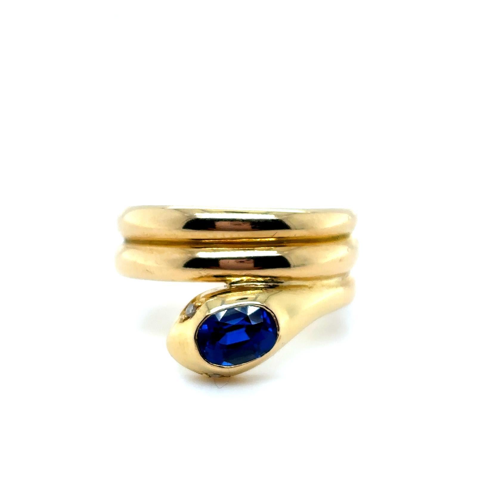 Vintage Sapphire Diamond 18 Karat Yellow Gold Snake Ring, Circa 1970

This charming snake ring, coils twice around the finger of the wearer.

Excellently crafted as a realistically modelled snake and grain set with rose cut diamond eyes of 0.02