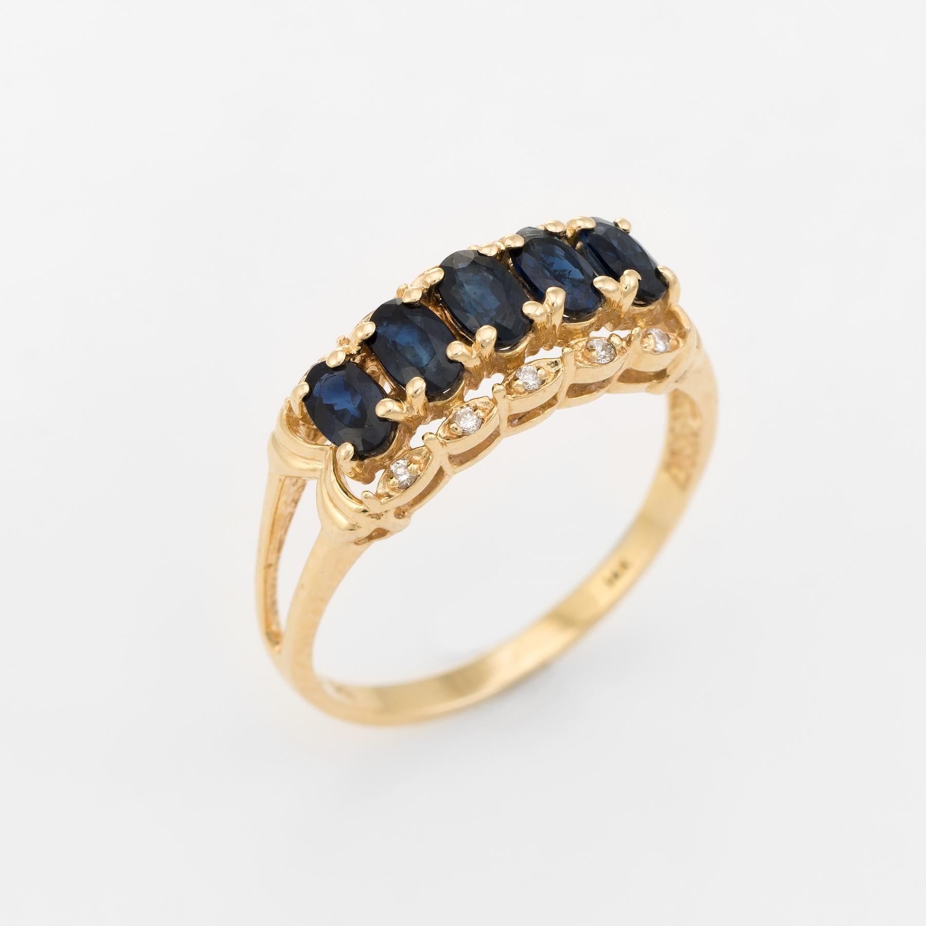 Finely detailed vintage anniversary band, crafted in 14 karat yellow gold. 

Faceted oval cut blue sapphires are uniform in size measuring 5mm x 3mm (estimated at 0.30 carats each - 1.50 carats total estimated weight). Ten round brilliant cut
