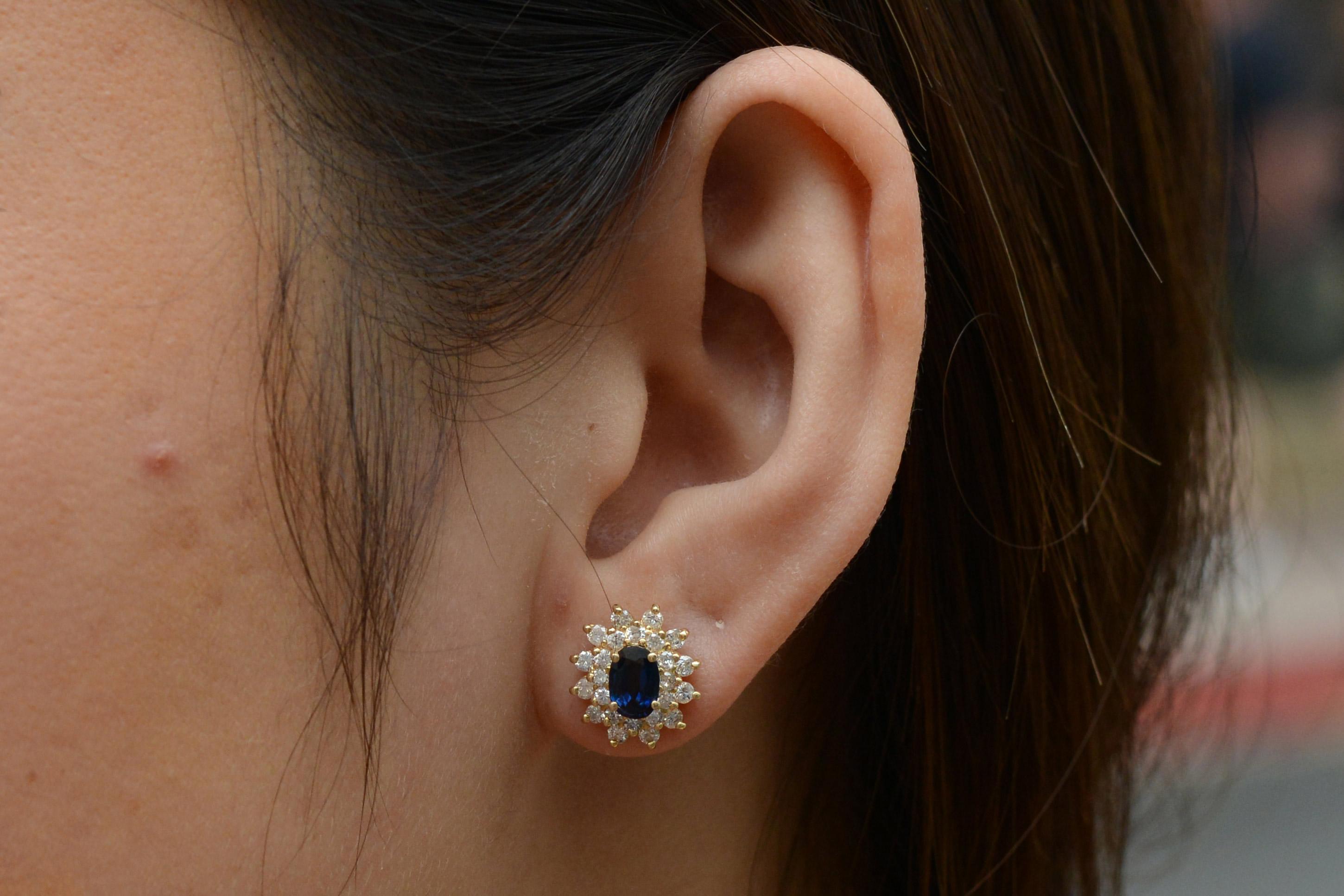 These chic vintage sapphire stud earrings offer an exquisite touch of sophistication and elegance. Adorned with naturally sourced sapphires at nearly 1.50 carats total presenting a deep navy blue hue. Laced with 48 shimmering accent diamonds