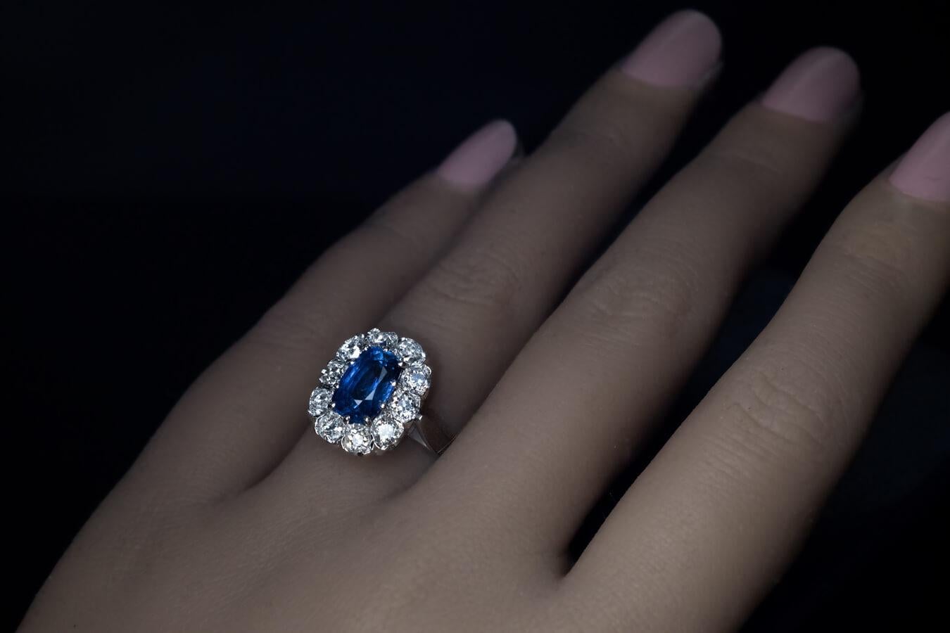 European, circa 1950
The ring is crafted in white 18K gold. It is centered with a cushion cut genuine sapphire measuring 9 x 5.9 x 4.9 mm. The sapphire is surrounded by pre-1900 chunky old mine cut diamonds (G-H color, VS1 – SI1 clarity).
Estimated