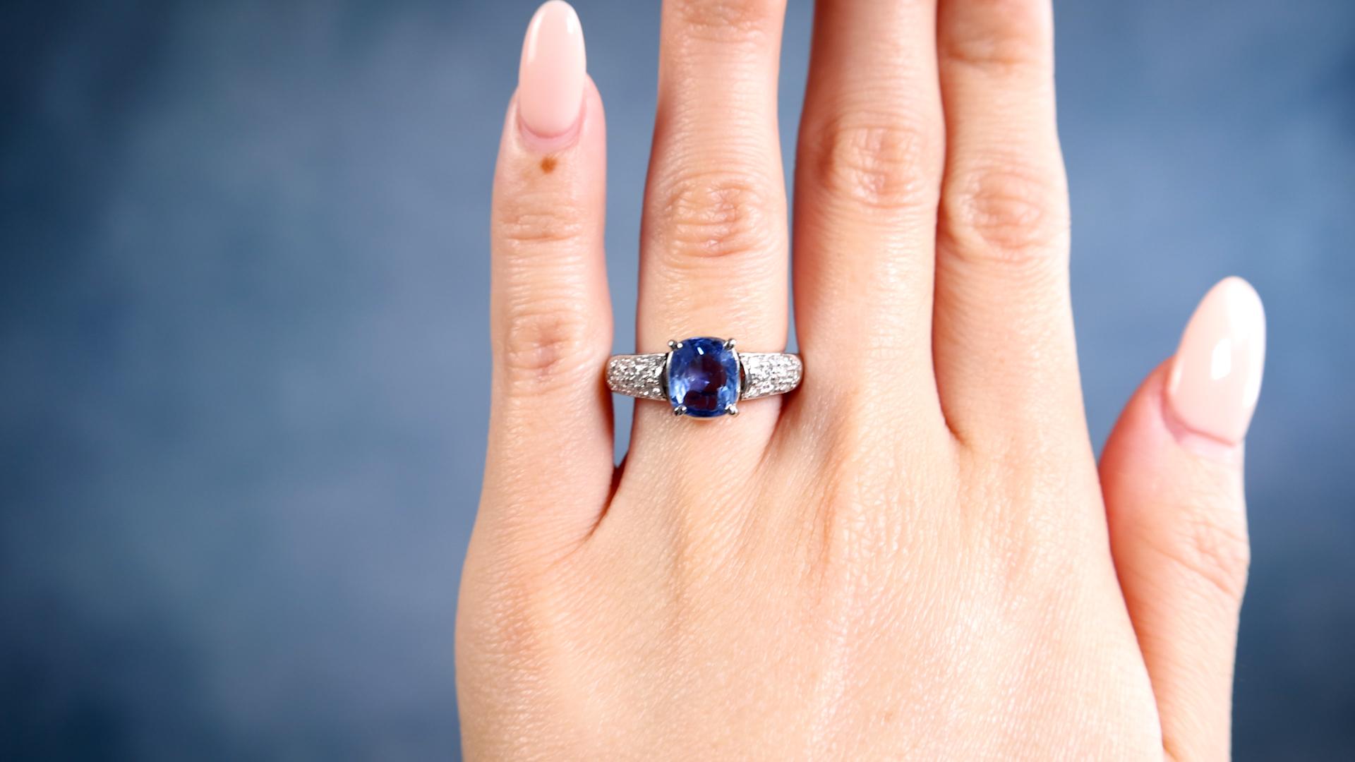 One Vintage Sapphire Diamond Platinum Ring. Featuring one cushion mixed cut sapphire of 2.21 carats. Accented by 18 round brilliant cut diamonds with a total weight of 0.30 carat, graded H-I color, VS clarity. Crafted in platinum with purity mark