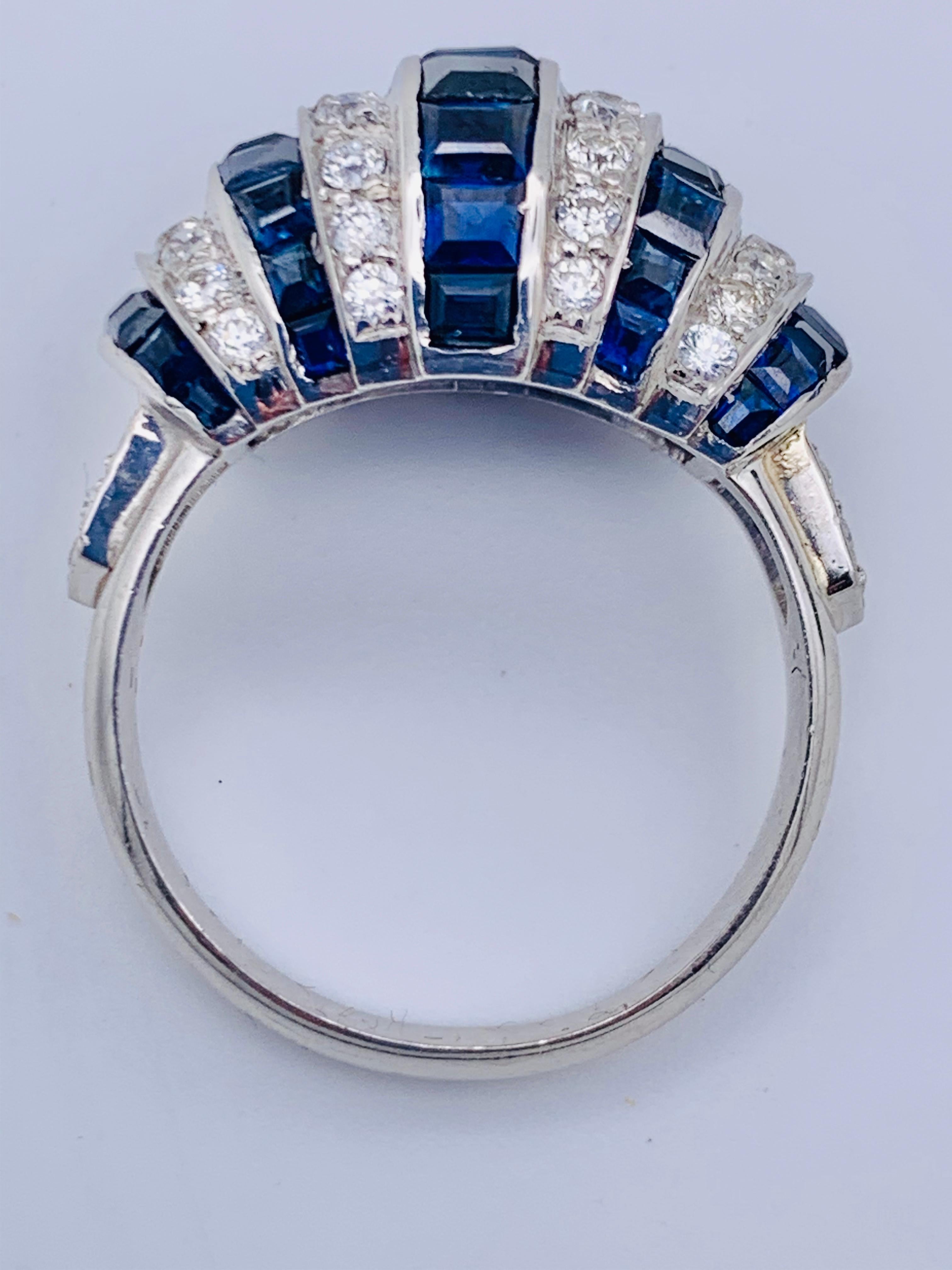 Very chique Art Deco style domed bombé ring with five rows of calibré cut sapphires alternating with 4 rows of brilliant cut diamonds.The ring sholders are decorated with five small dimonds each.
The ring holds 42 diamonds with a total weight of