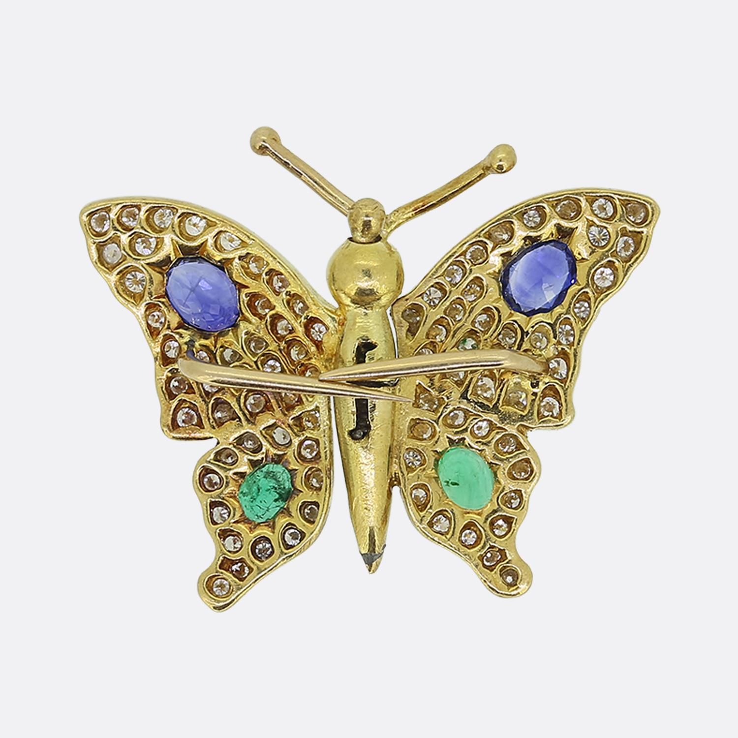 Here we have a wonderful butterfly brooch crafted in 18ct yellow gold. It features Sapphires, emeralds and diamonds on the wings and it is finished with cabochon ruby eyes. It also has an easy to use mechanism, where you simply fold the wings inward