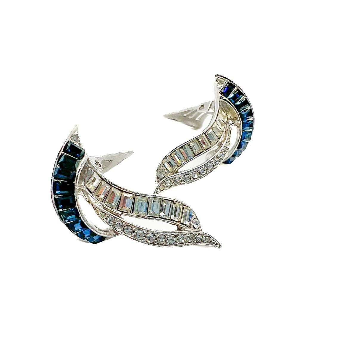 A pair of Vintage Sapphire Paste Swoosh Earrings. A delightful design, quite possibly Boucher featuring sapphire and white crystals in fancy cut baguette stones and chatons. Inspired by the Art Deco period the design and craftmanship, let alone the