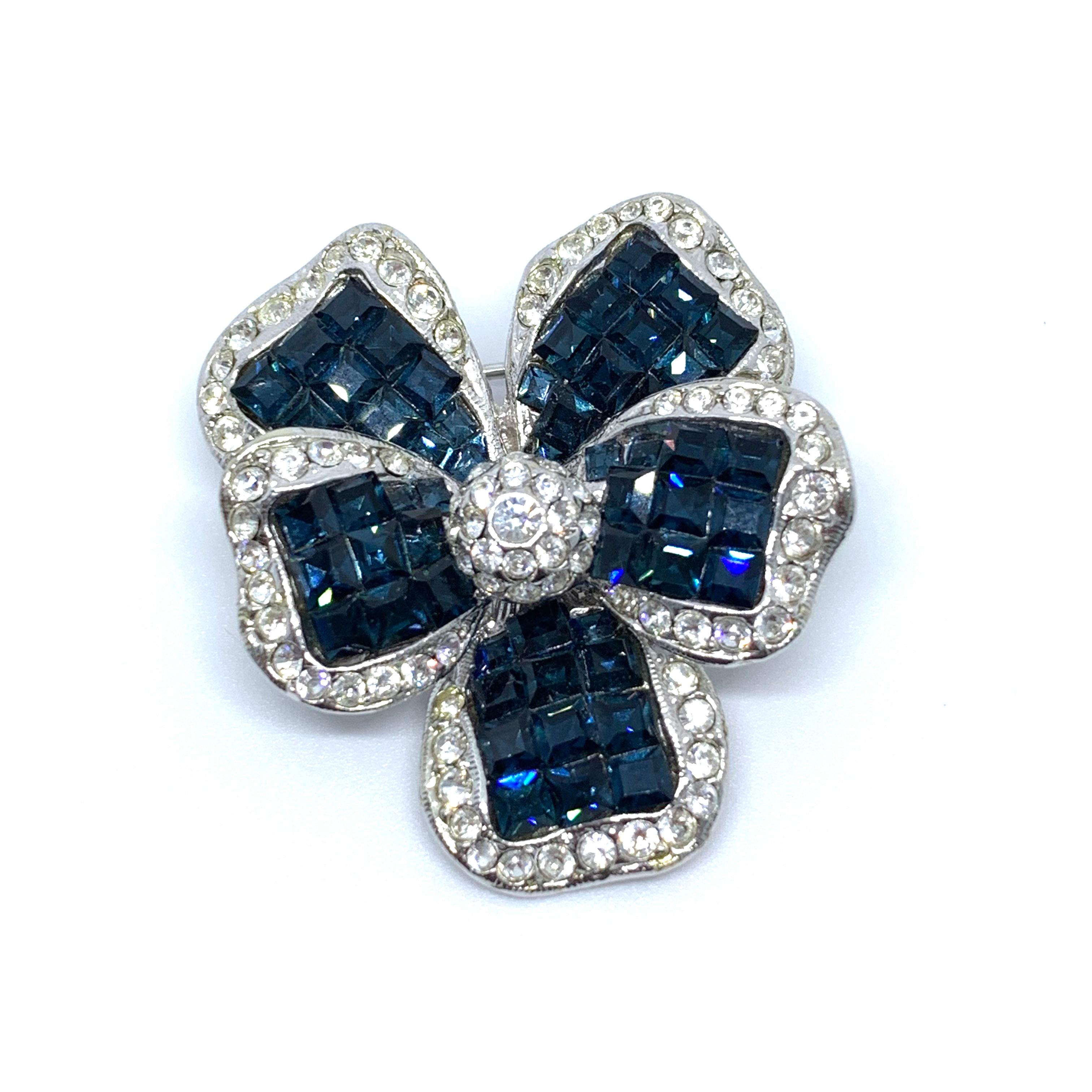 Classic Elegant Vintage Sapphire Swarovski Crystal Flower Brooch

This vintage brooch features over 150 pieces of square cut sapphire and round white Swarovski crystals in white gold tone. Made in the USA by New York designer brand Jarin.  1-1/2