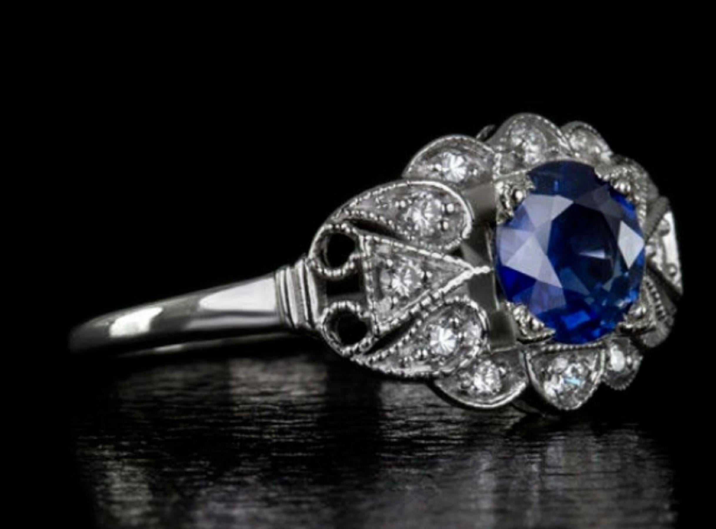 The sapphire has a gorgeous blue color that radiates in the light. 

The stone is complimented by 10 white diamonds which are free from any visible imperfections and have nice sparkle! This ring was inspired by a ring from the Art Deco era and has a